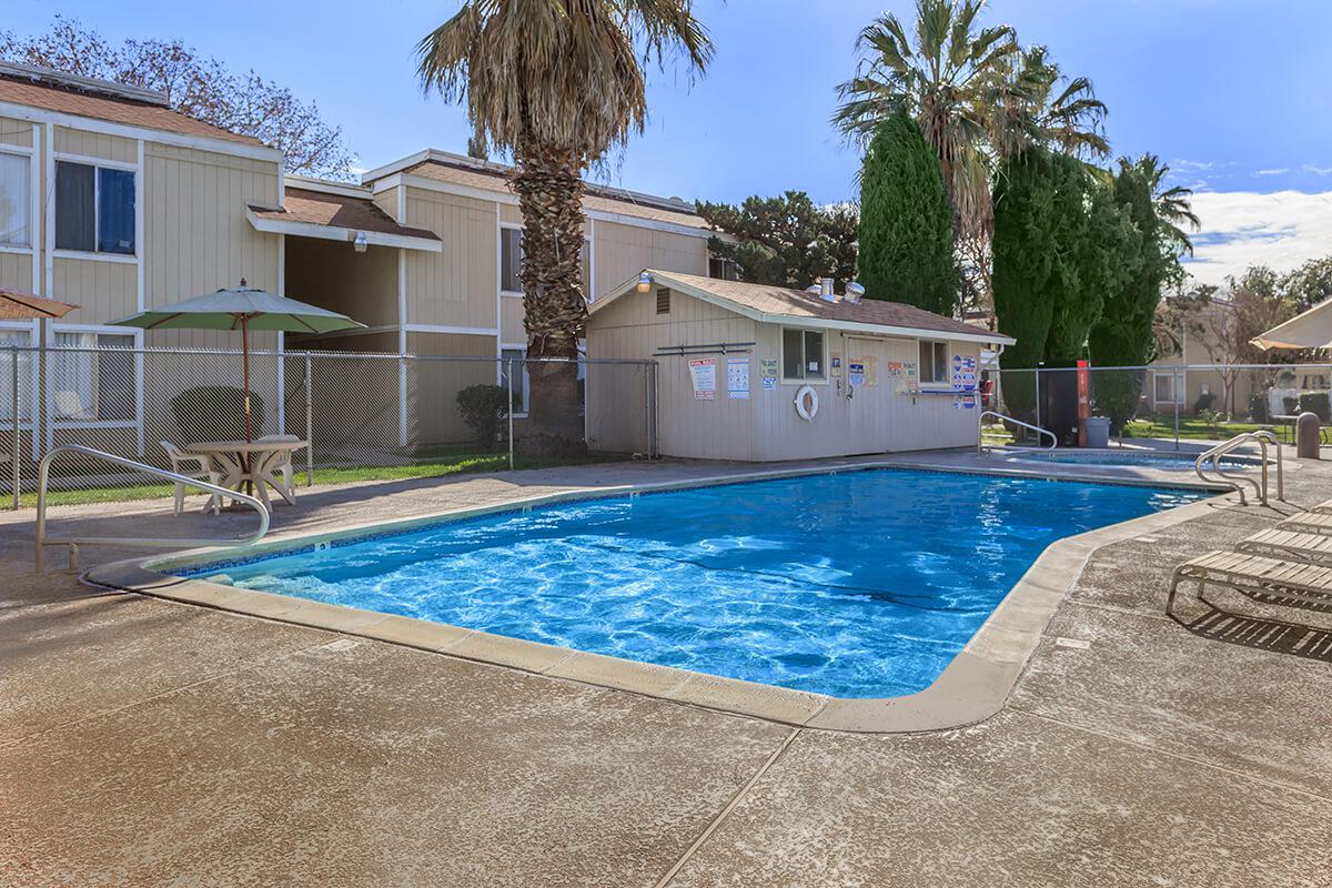 a house with a pool outside of a building