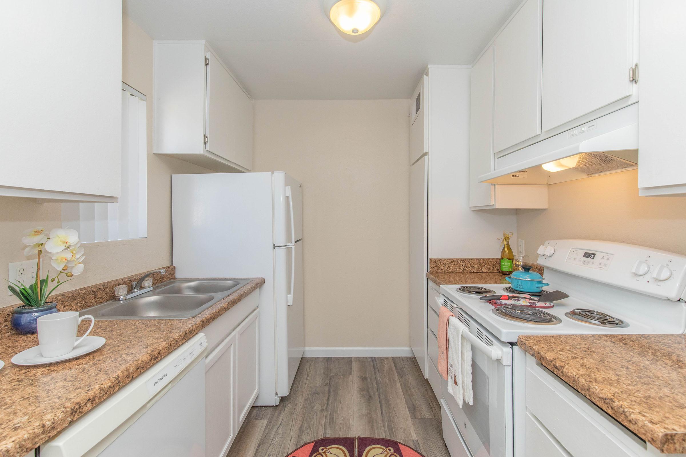 a kitchen with a sink and a mirror