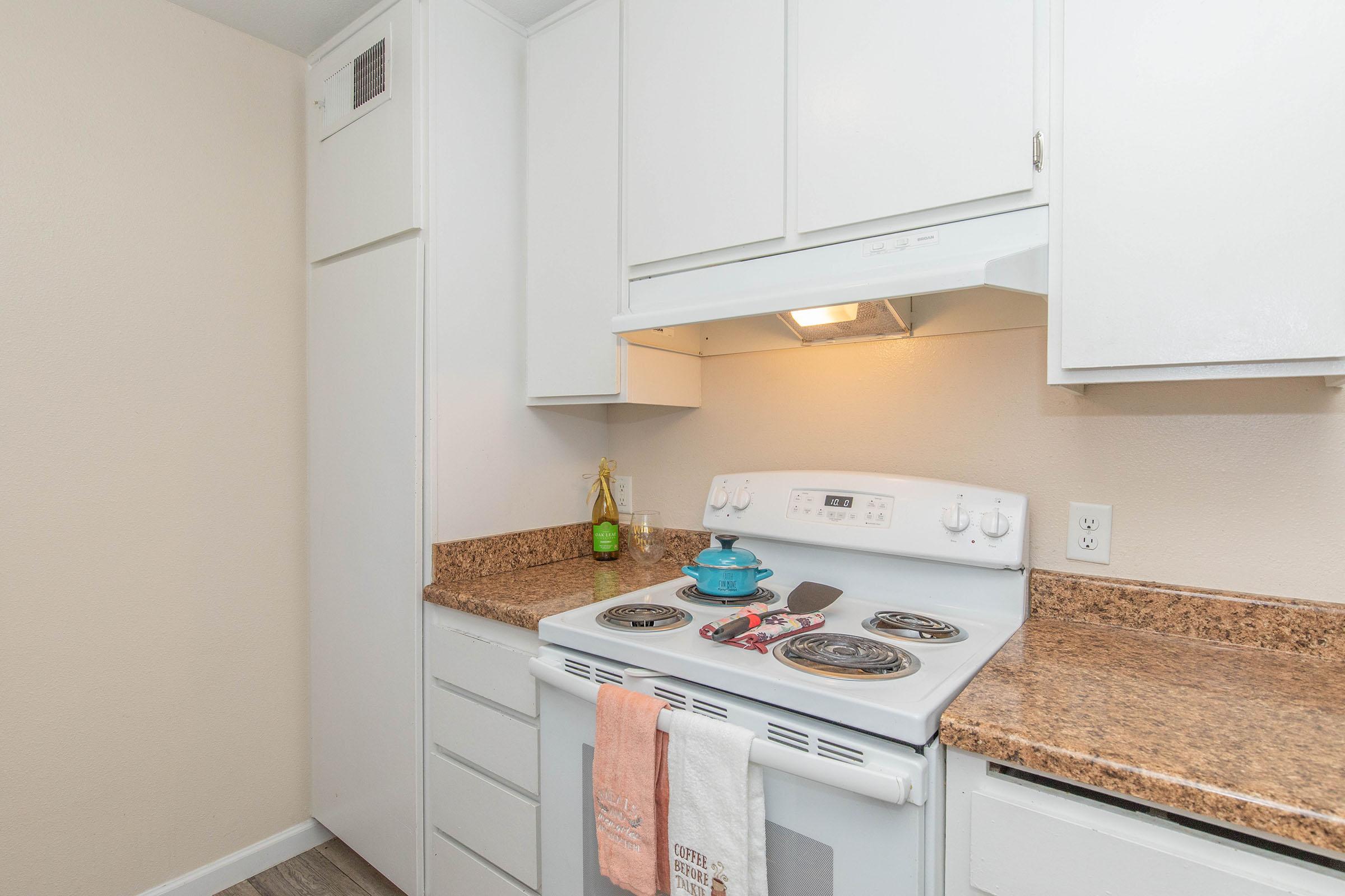 a kitchen with a stove top oven sitting inside of a refrigerator