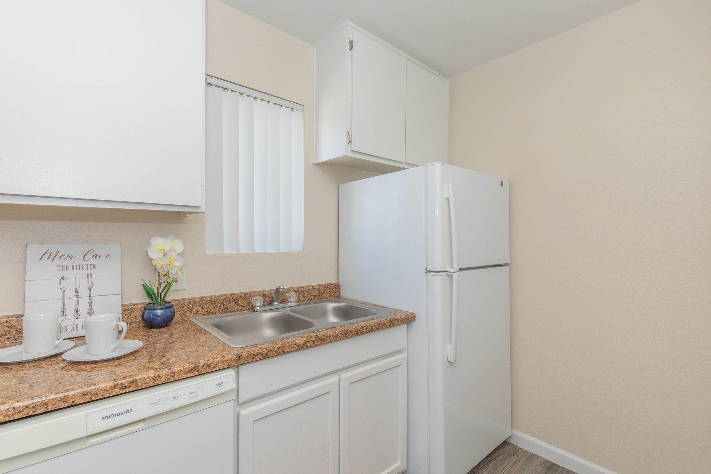 a kitchen with a sink and a refrigerator