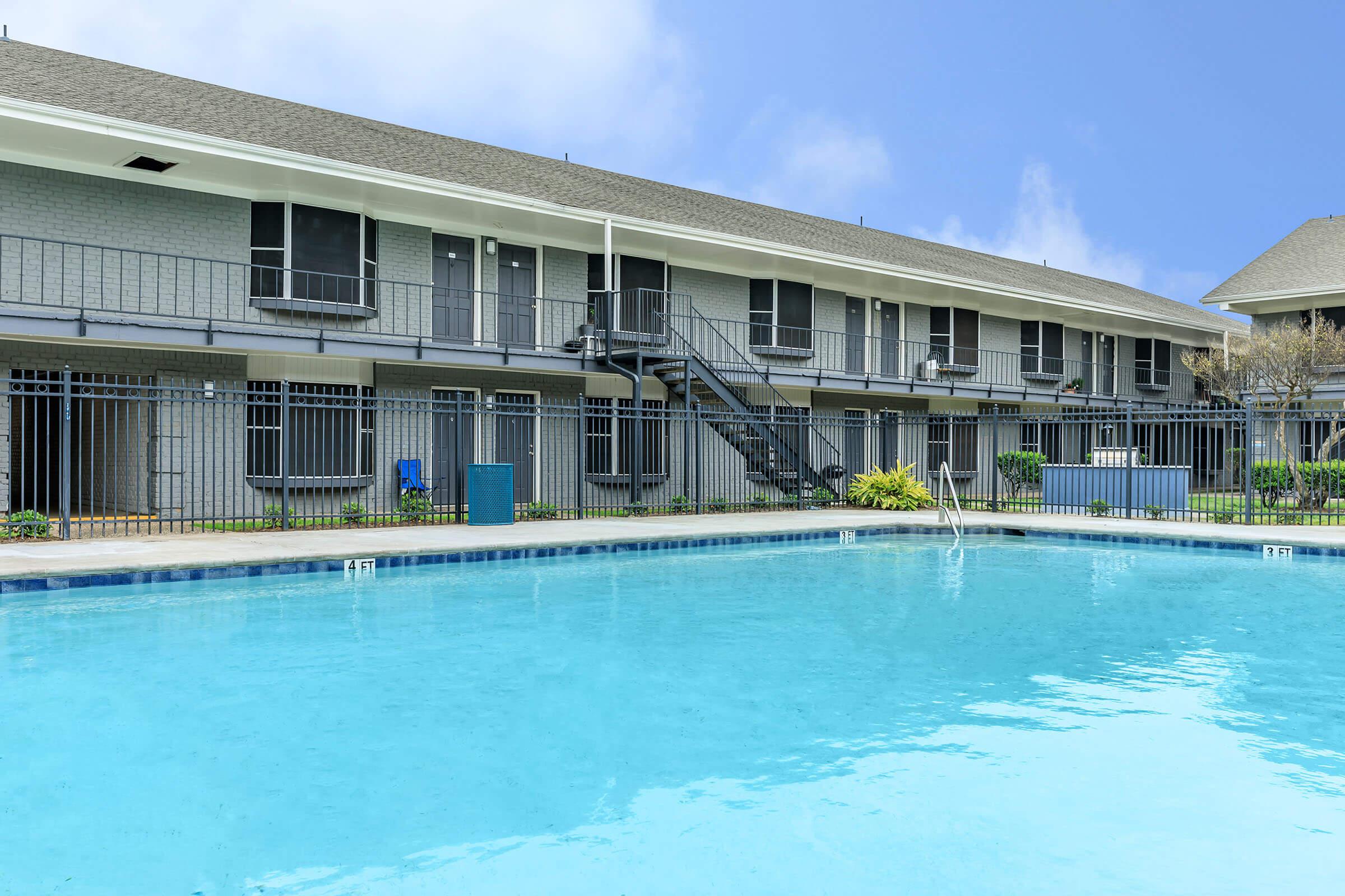 a large pool of water in front of a house