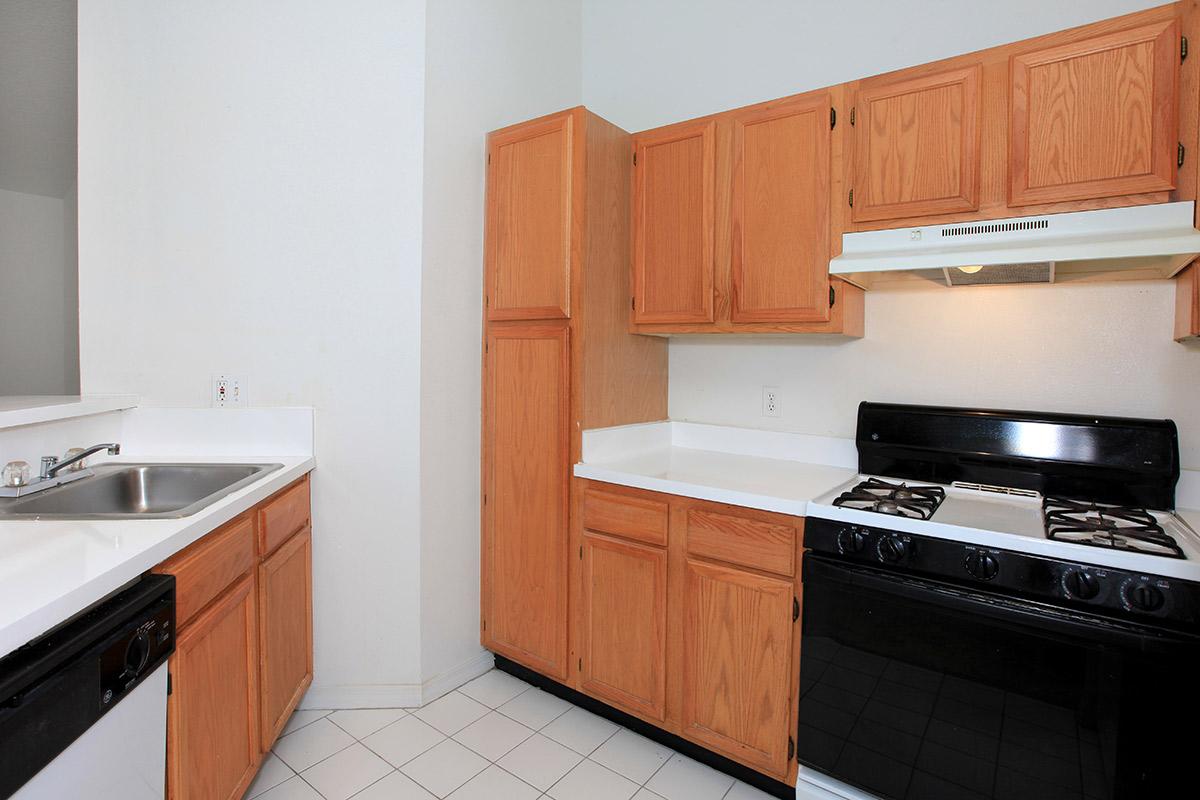 a kitchen with a stove a sink and a microwave
