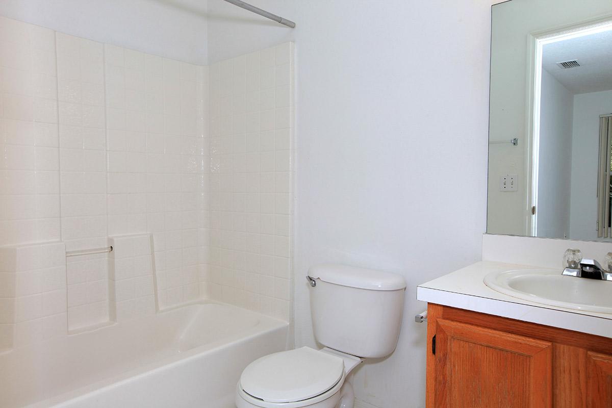 a white tub sitting next to a sink