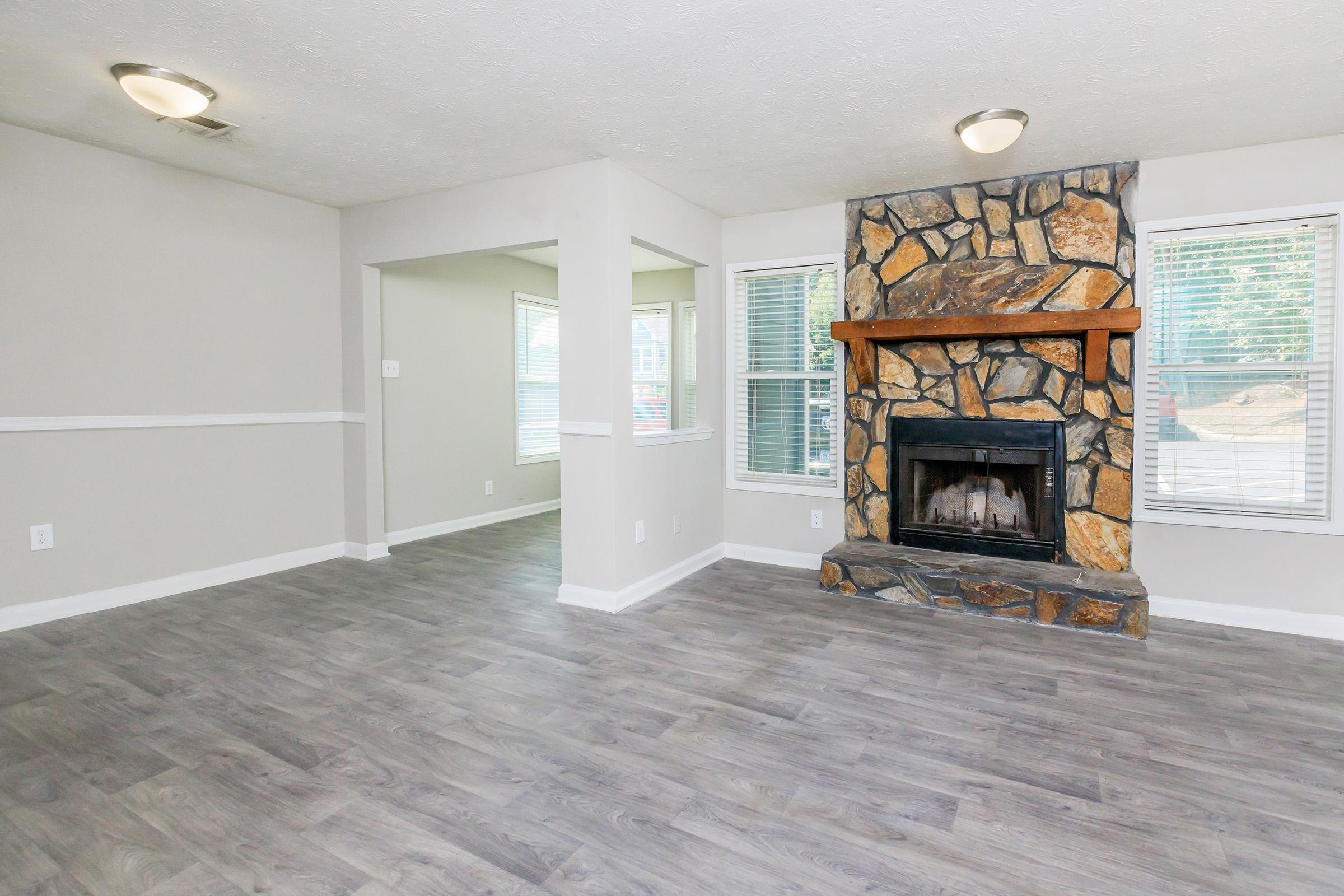 a living room filled with furniture and a fireplace