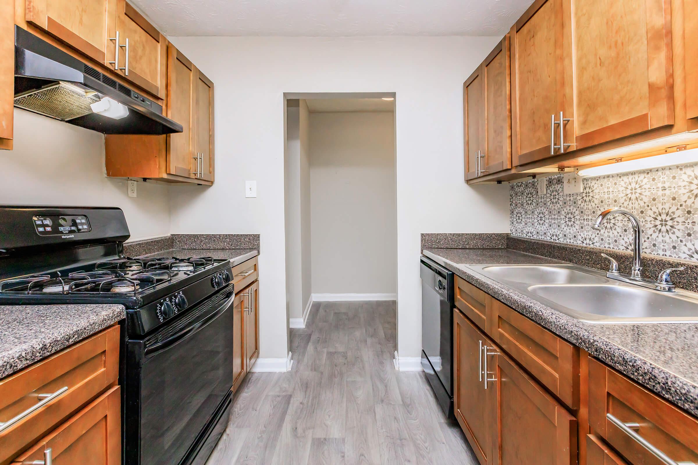 a modern kitchen with stainless steel appliances and wooden cabinets