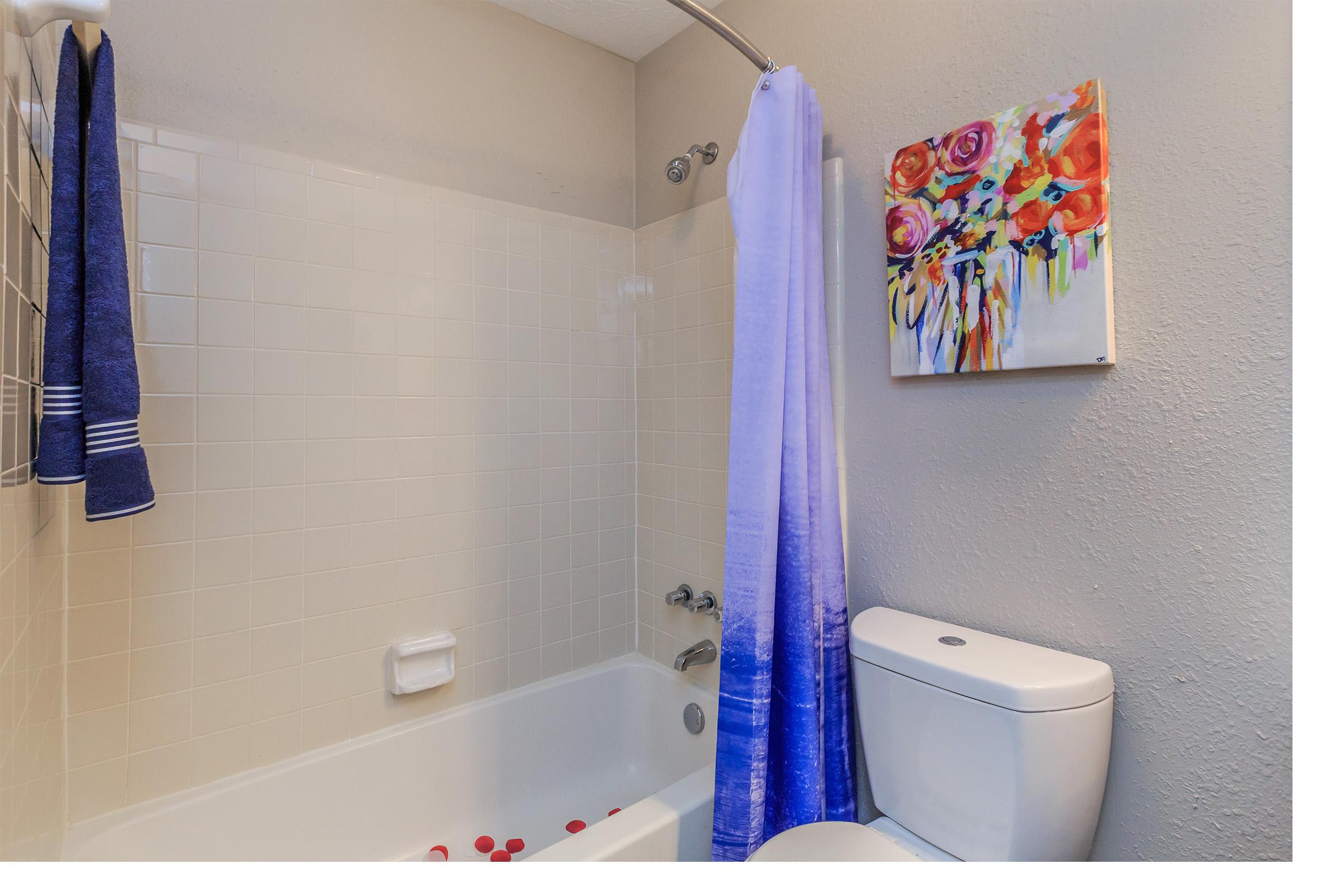 a white sink sitting next to a shower