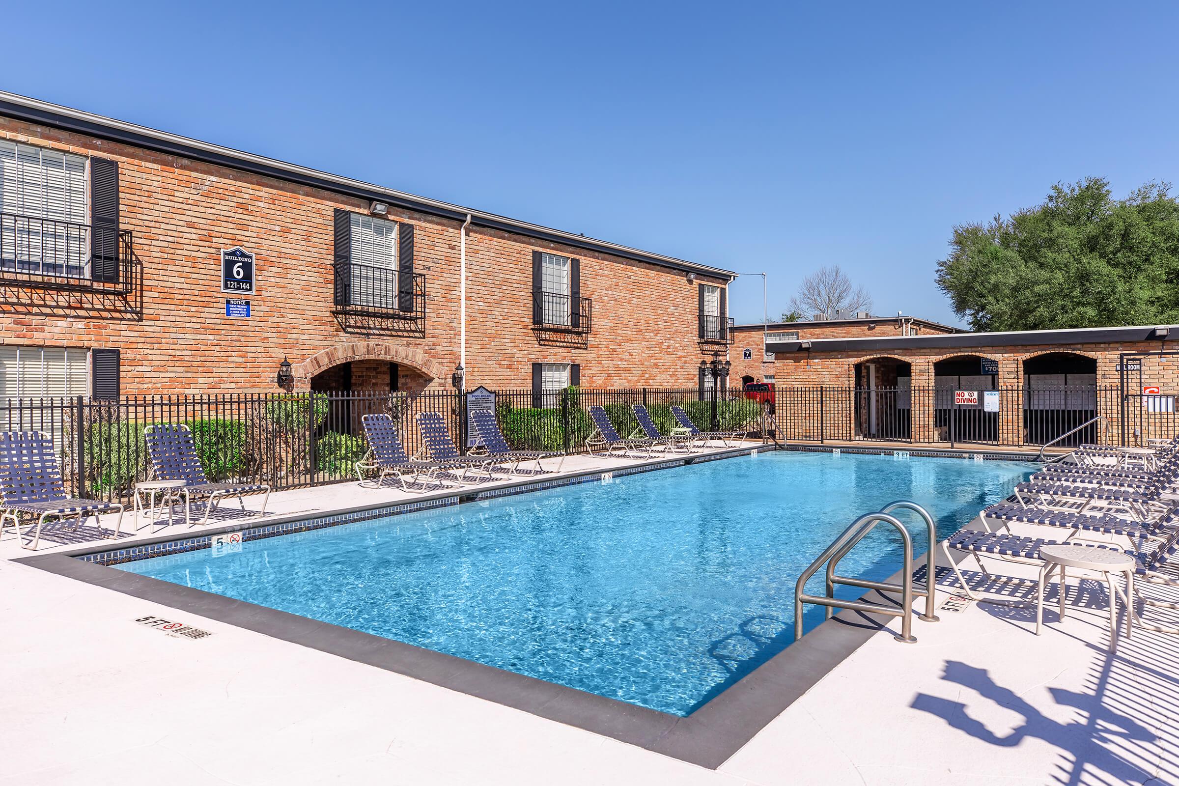 a house with a pool in front of a building