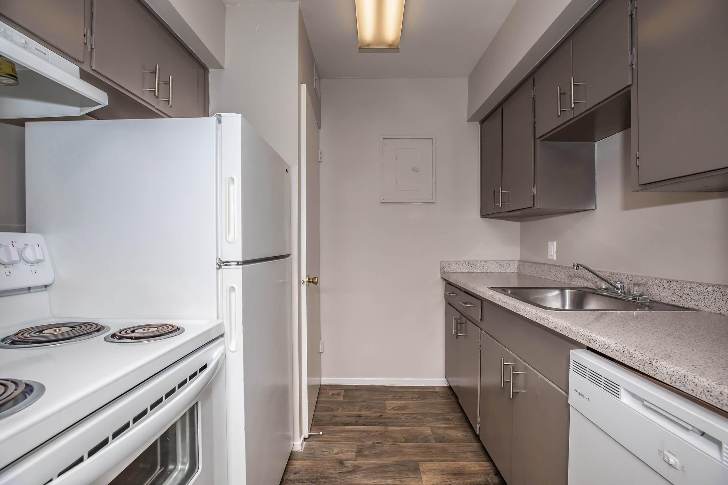 a kitchen with a stove sink and refrigerator