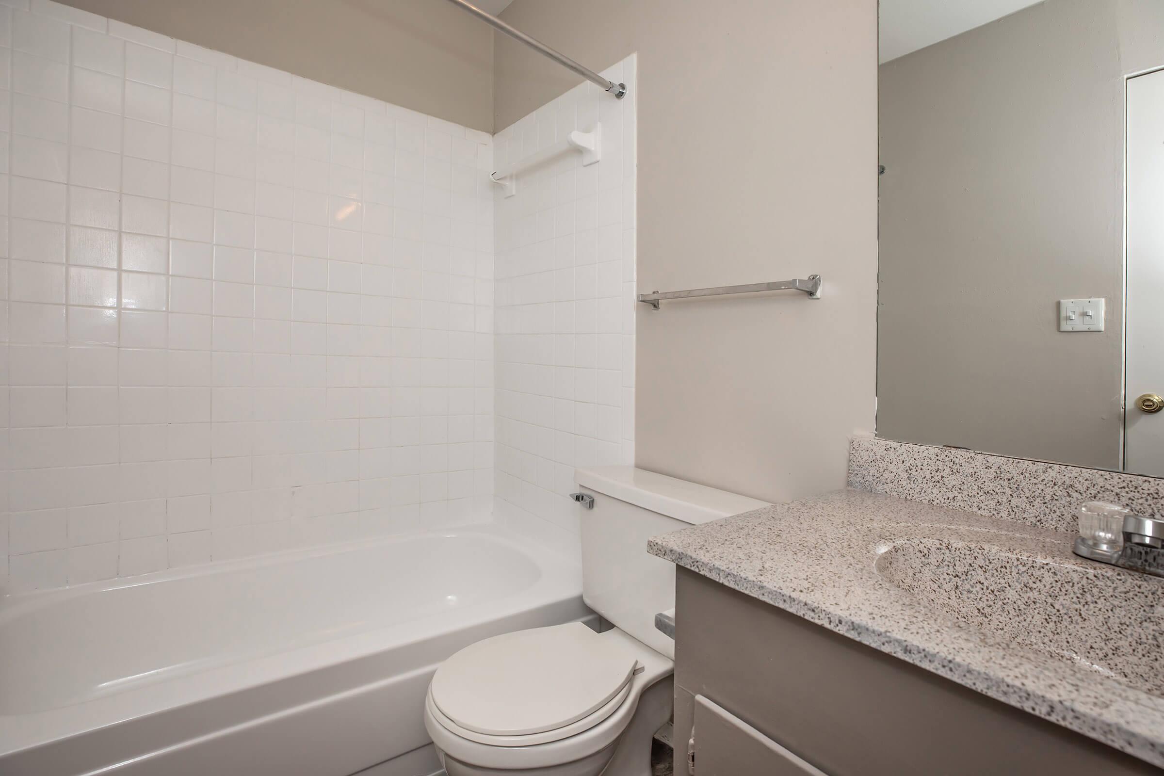 a white tub sitting next to a sink