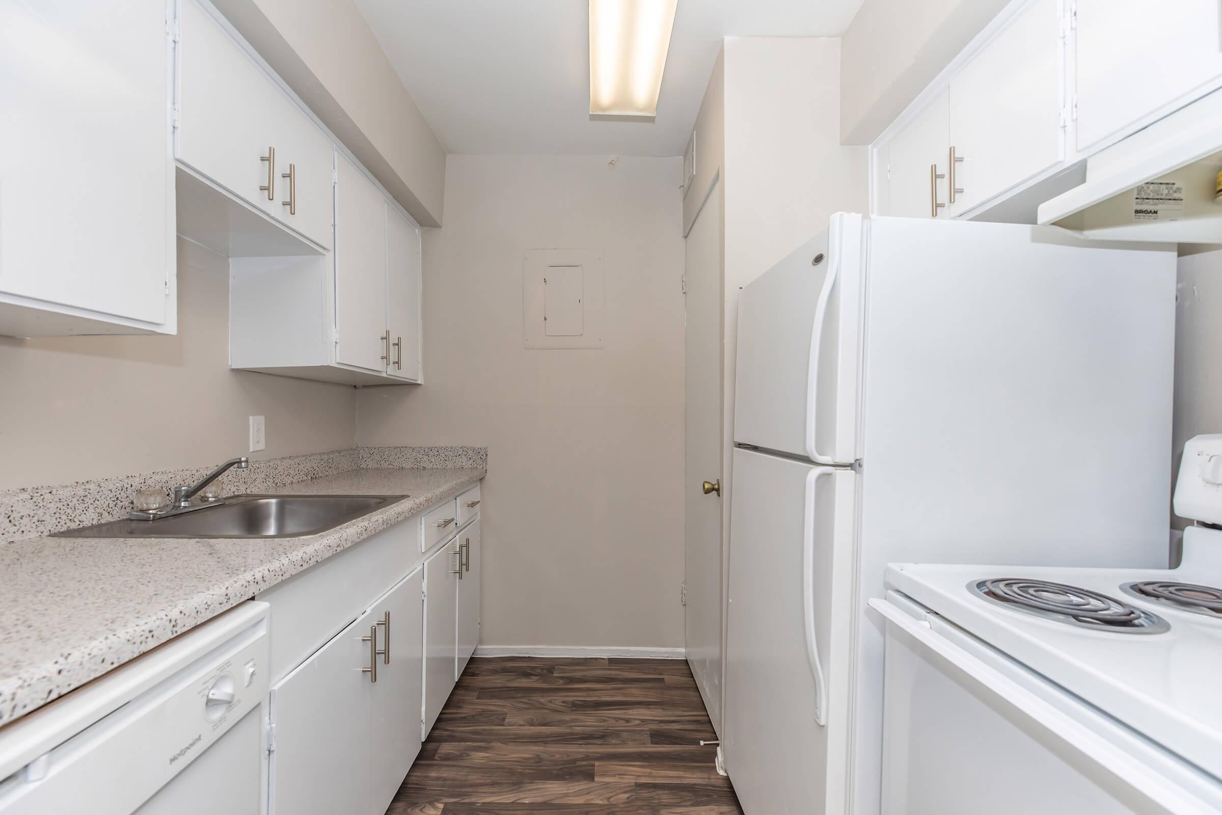 a kitchen with a stove sink and refrigerator