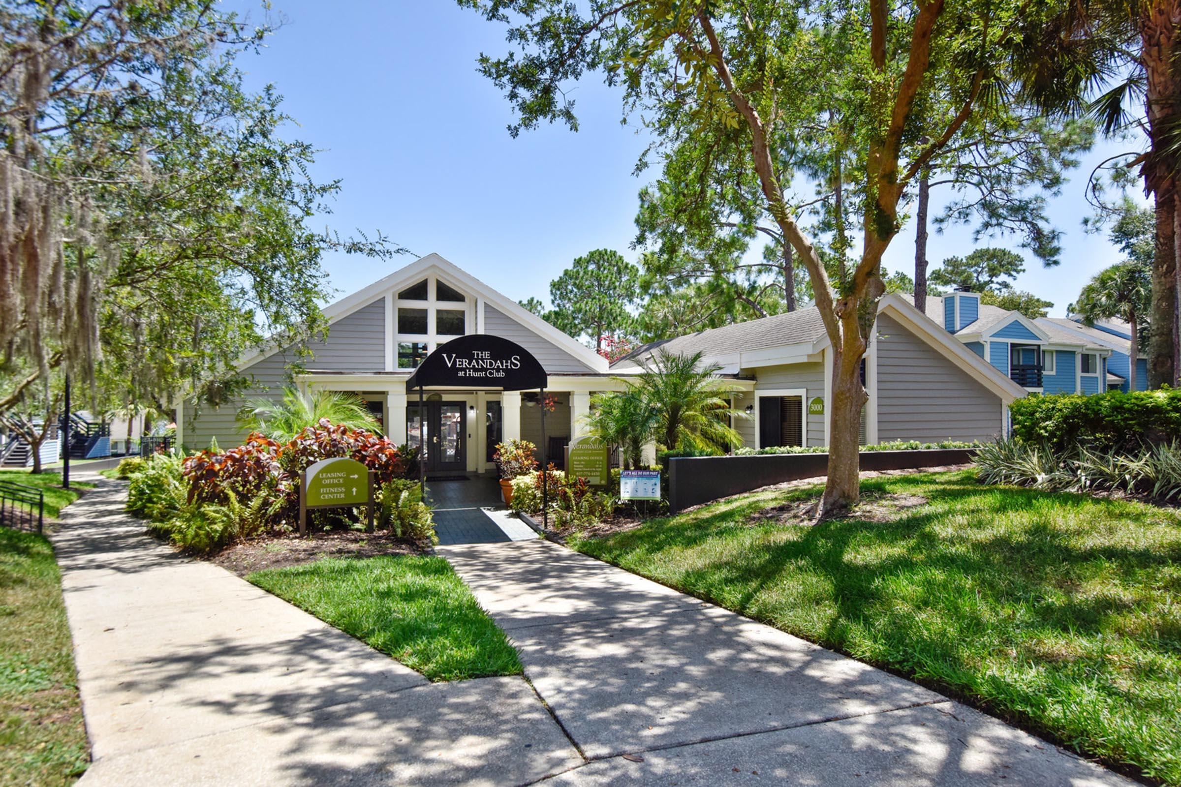 a path with grass in front of a house