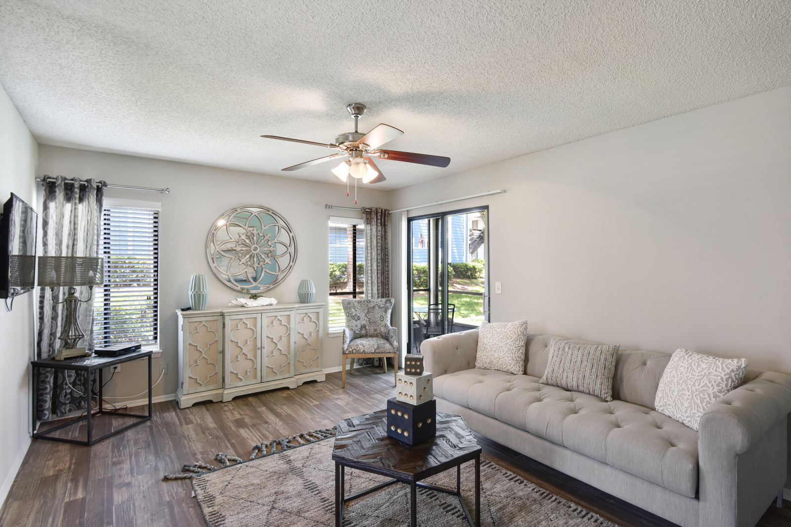 a living room filled with furniture and a large window