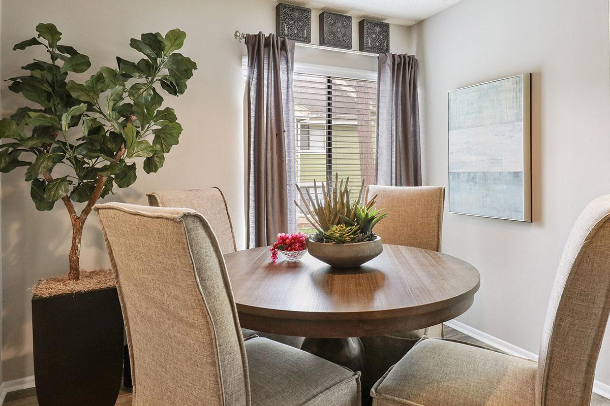 a room filled with furniture and vase of flowers on a table