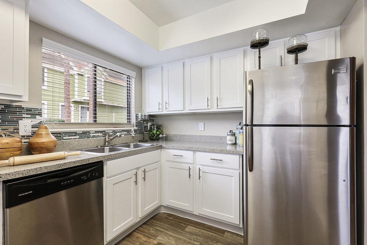 a large kitchen with stainless steel appliances