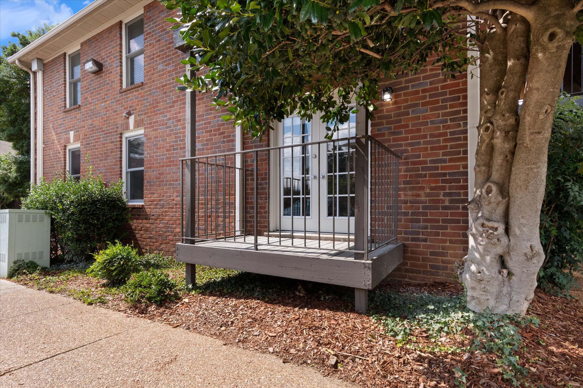 a bench in front of a brick building