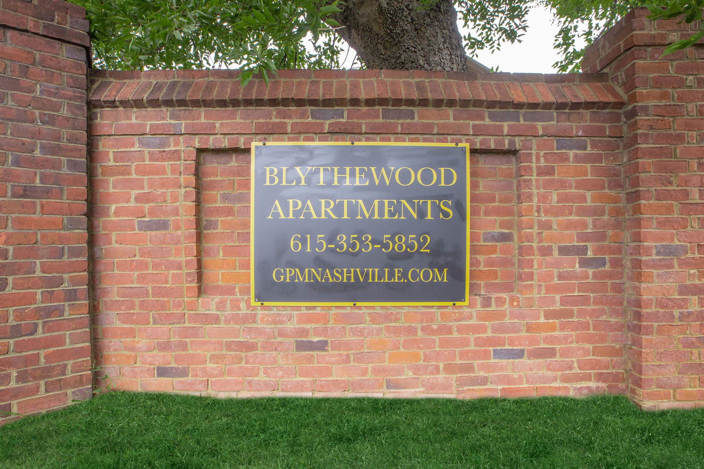 a sign on a brick wall