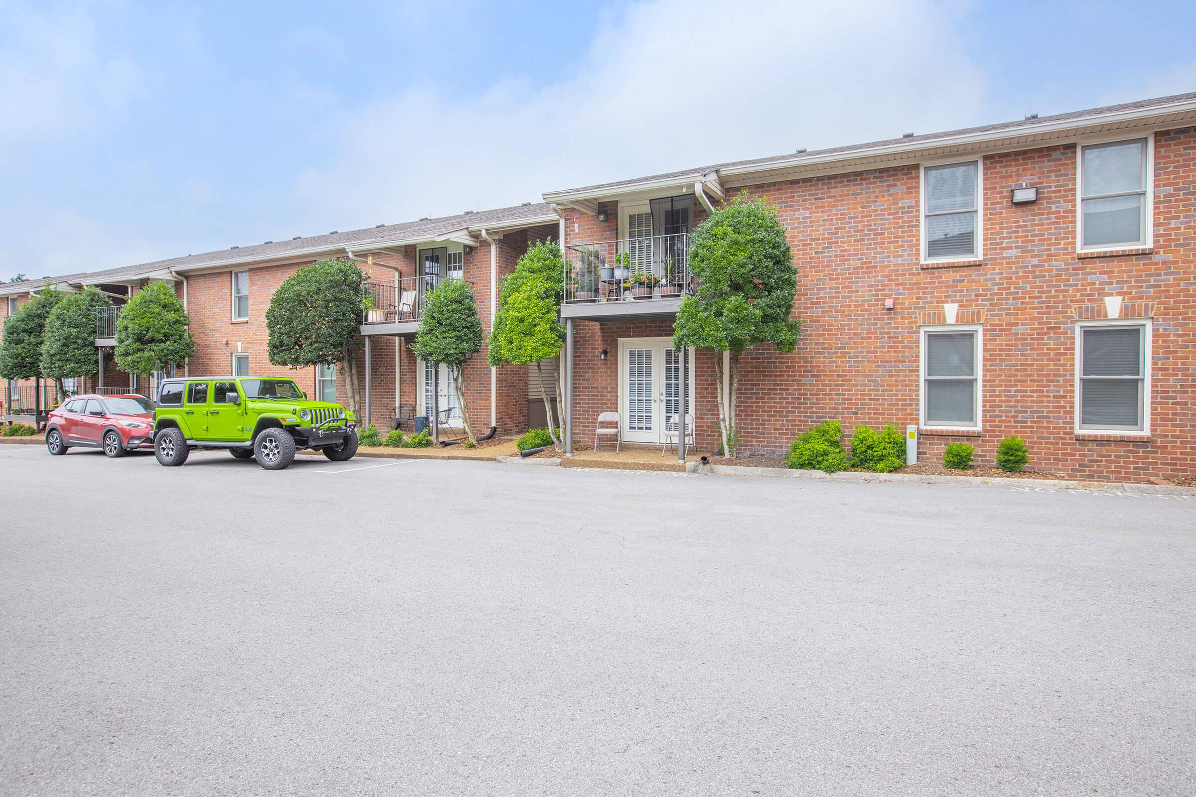 a large brick building with a parking lot