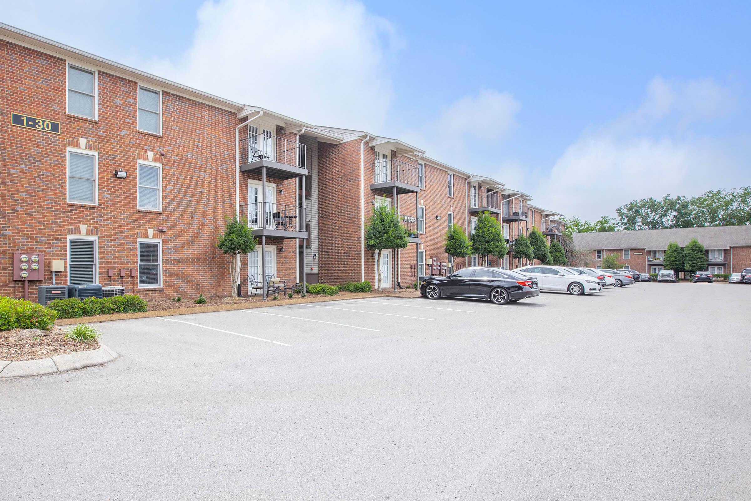 a large brick building with a parking lot