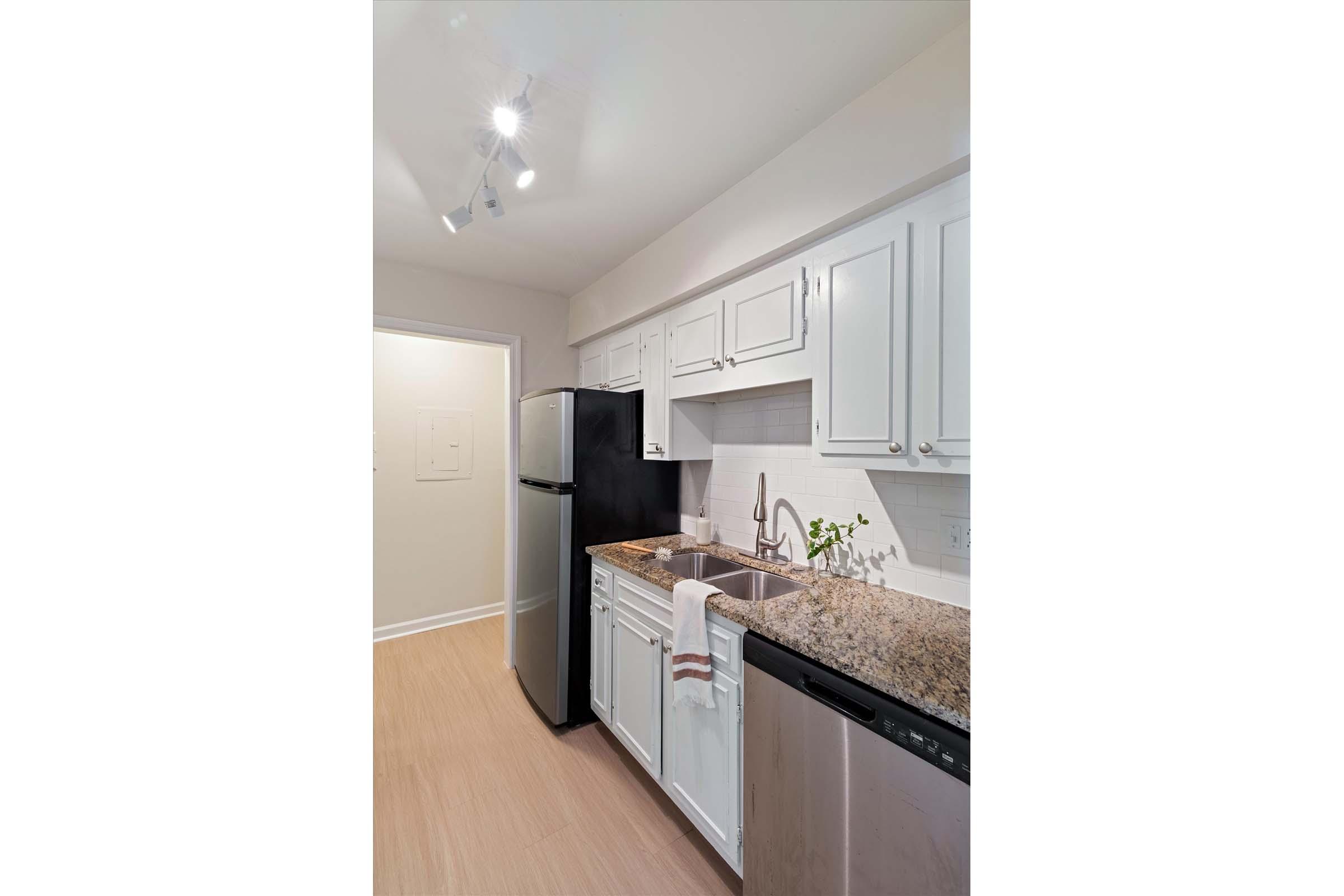 a kitchen with a sink and a refrigerator