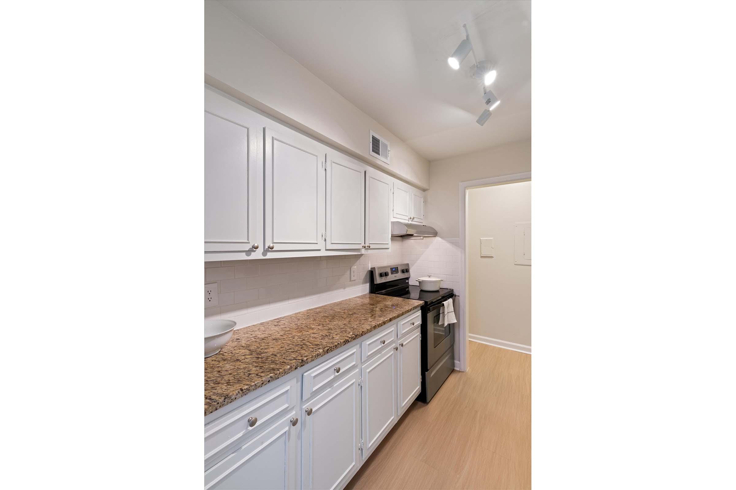 a kitchen with wooden cabinets