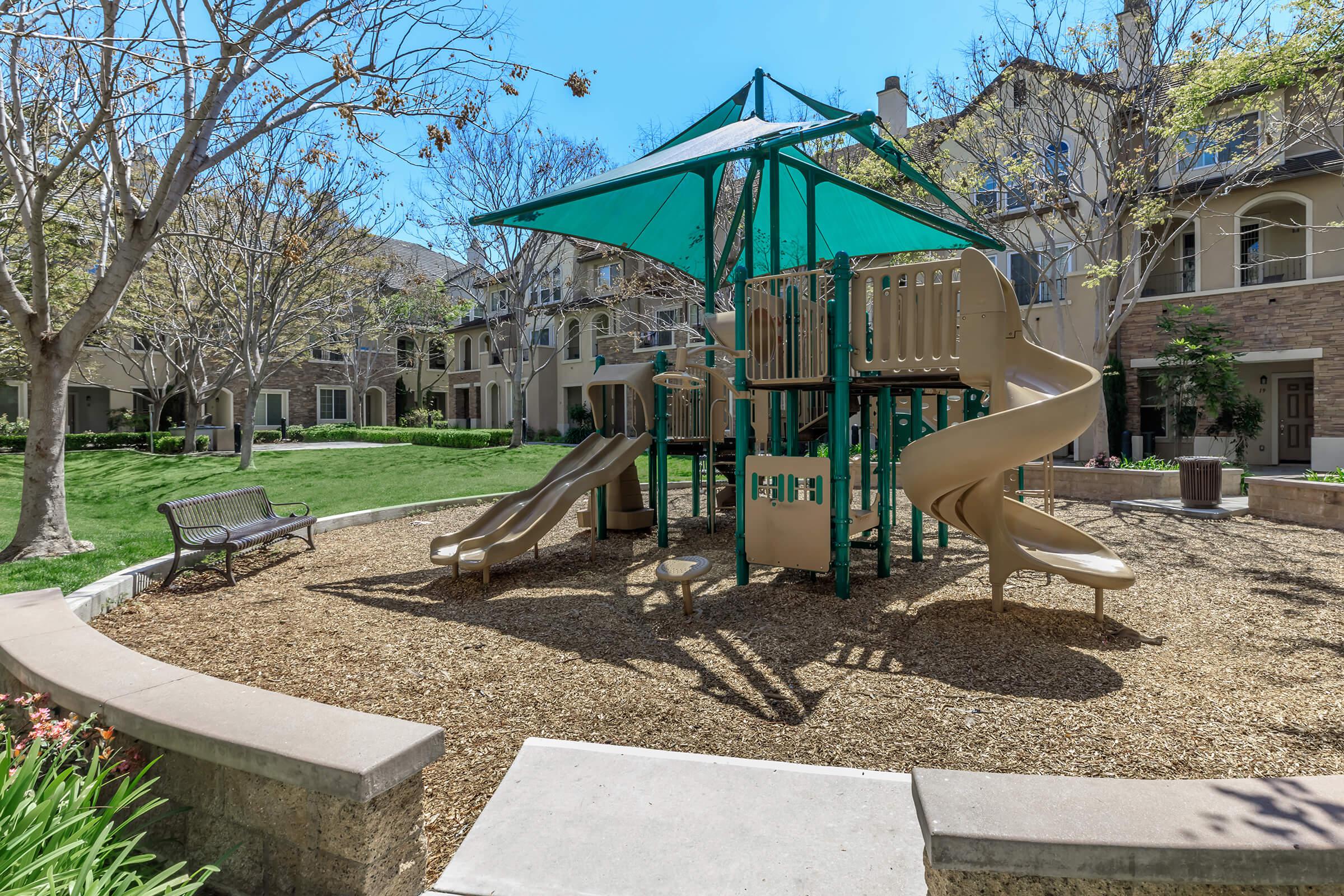 Three-Bedroom Townhomes in Chula Vista, CA - Contessa at Otay Ranch - A Playground with a Large Play Structure with Slides and Climbing Areas.