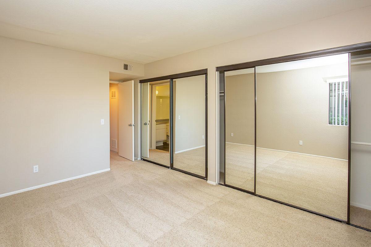 Bedroom with two sets of glass mirror sliding closet doors