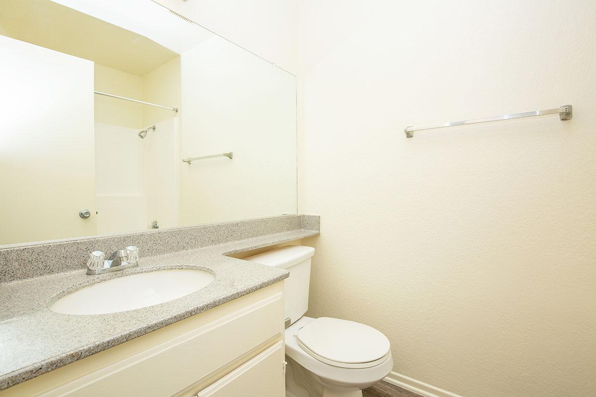 Unfurnished bathroom with white cabinets