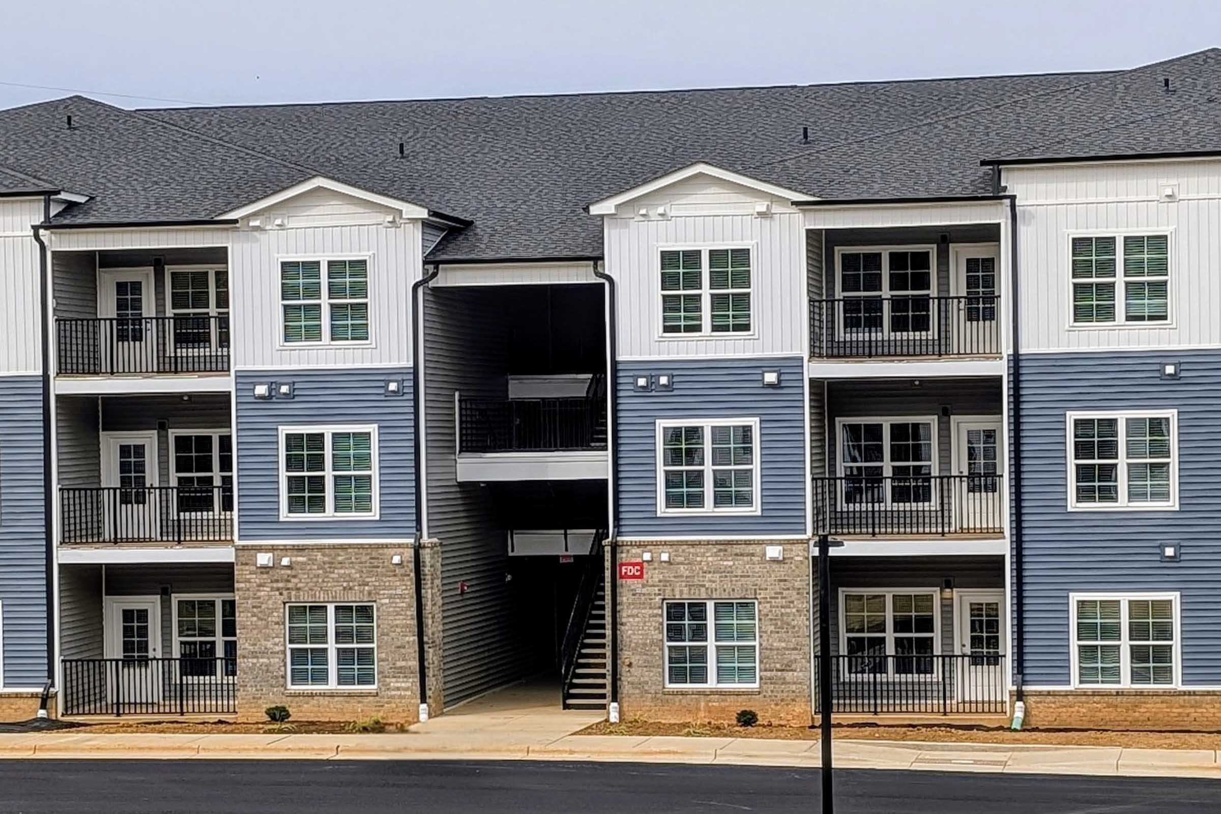 a house in front of a brick building