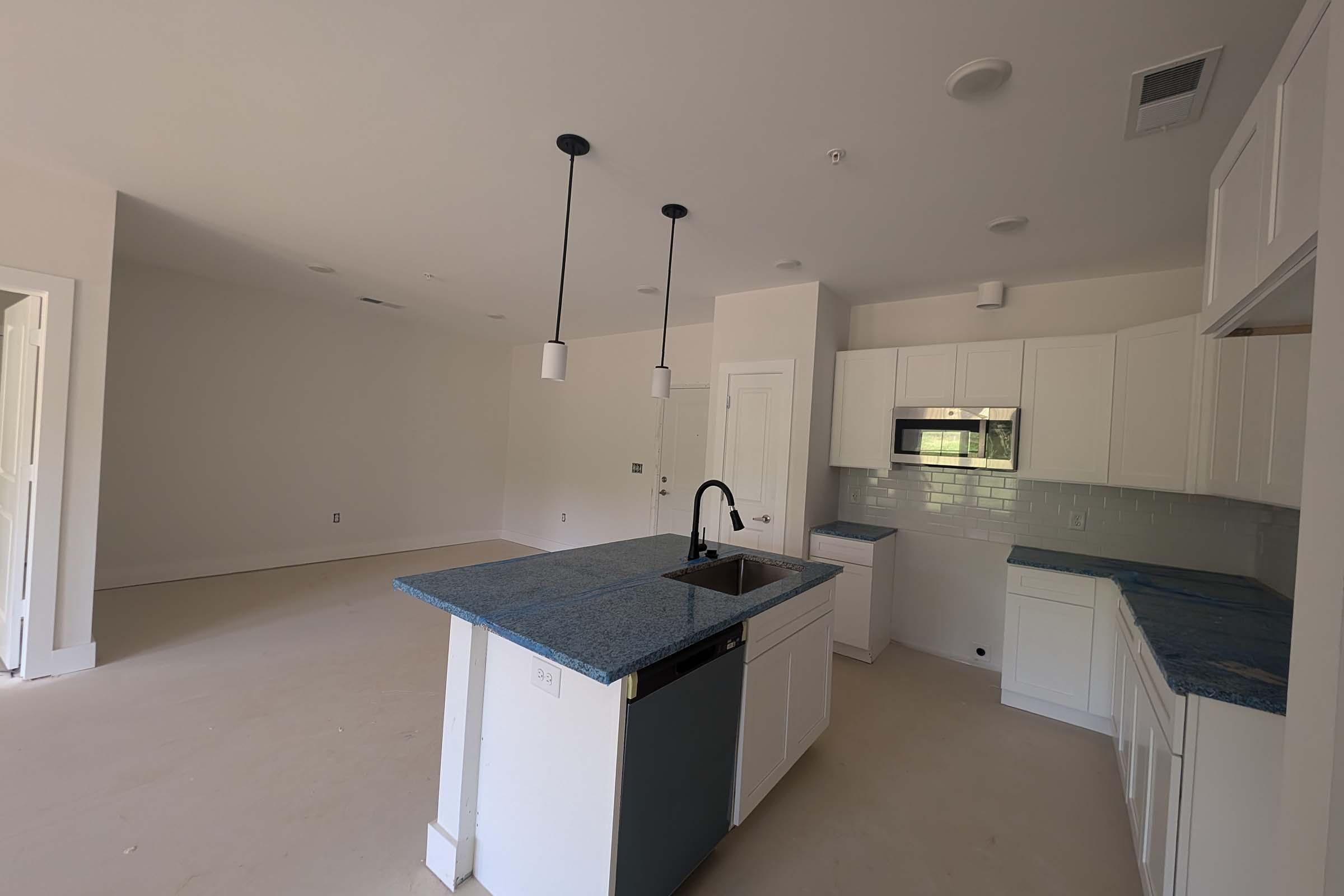 a kitchen with a sink and a refrigerator