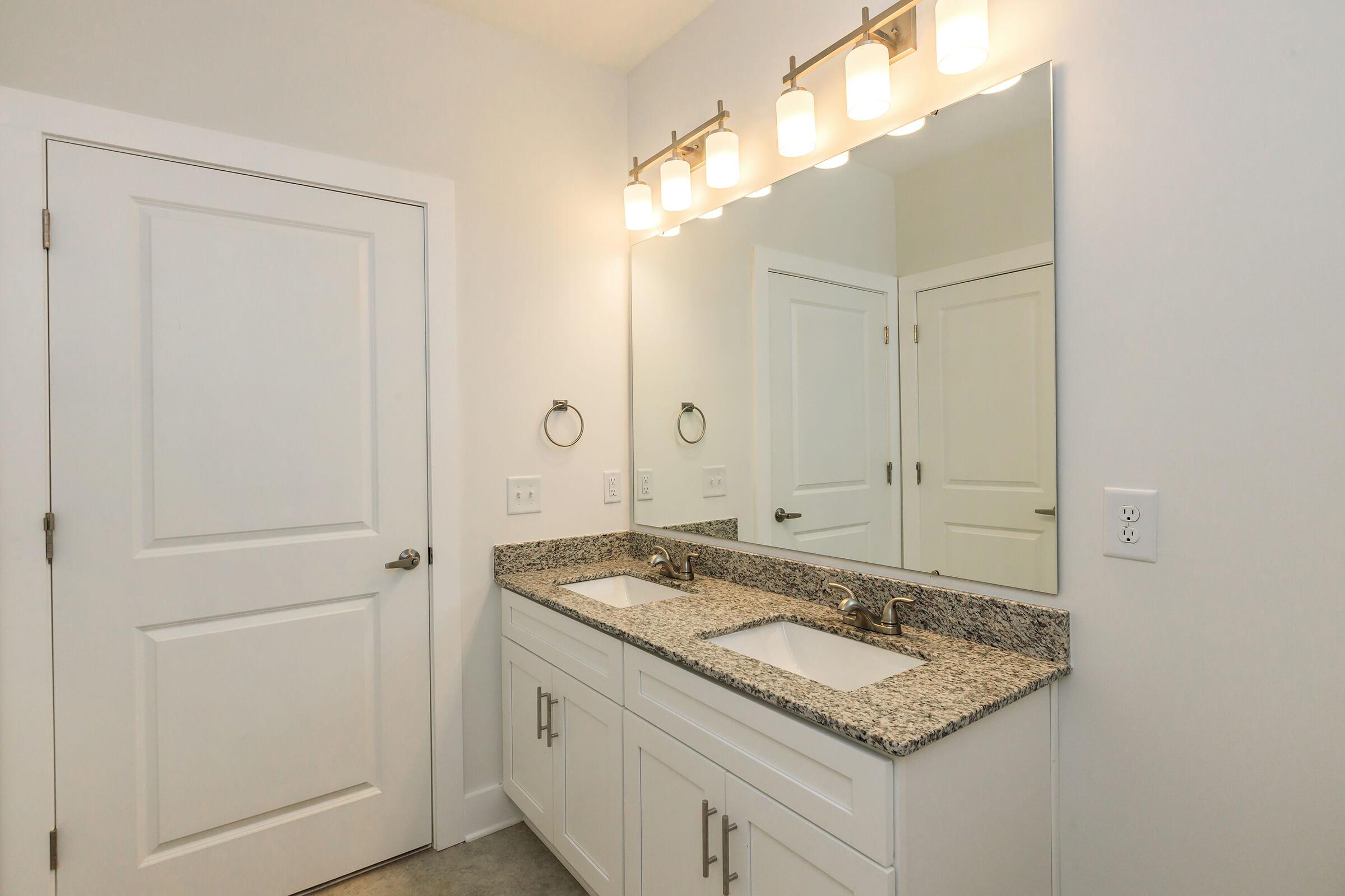 a kitchen with a sink and a mirror