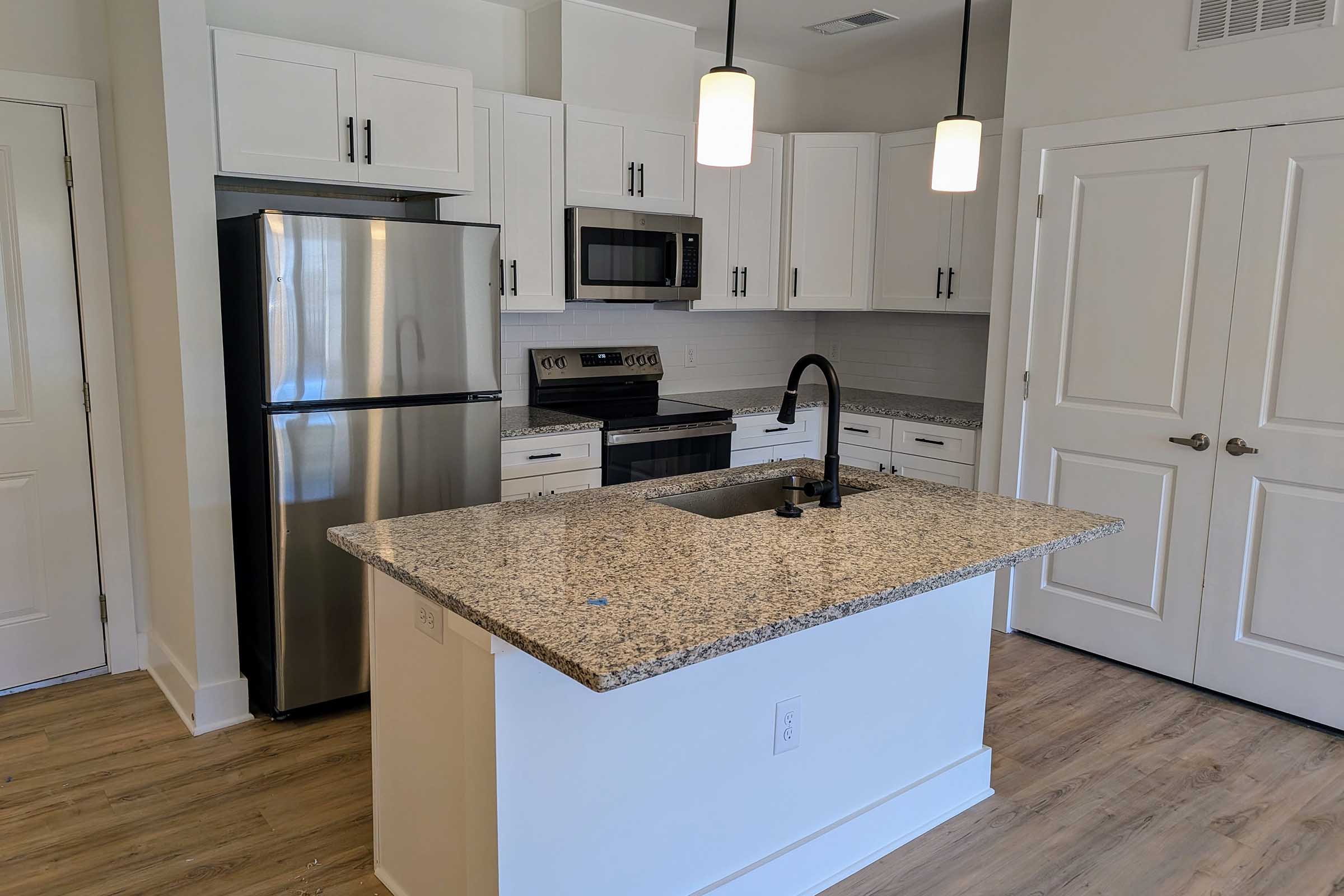 a kitchen with a stove and a refrigerator