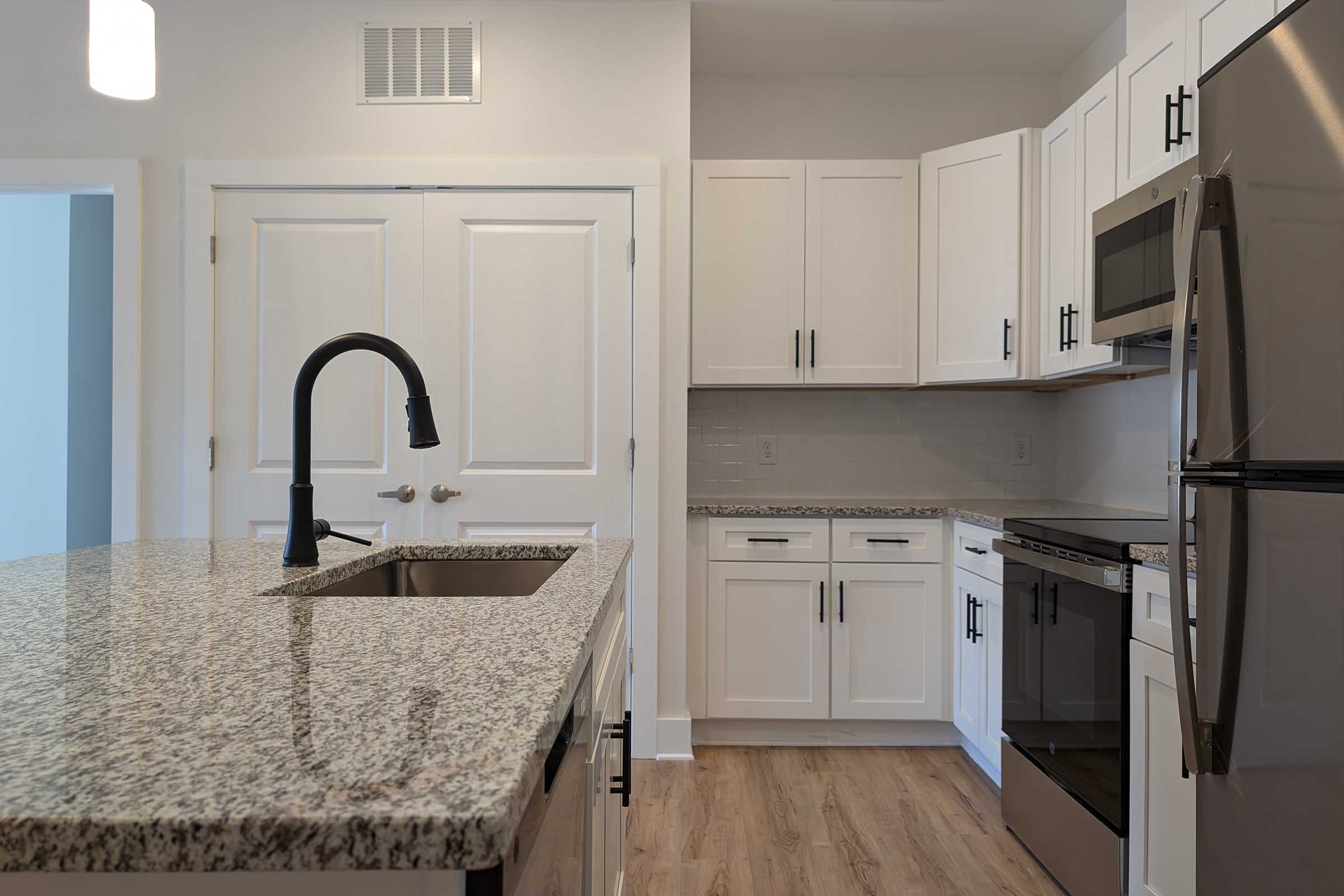 a kitchen with a stove and a refrigerator