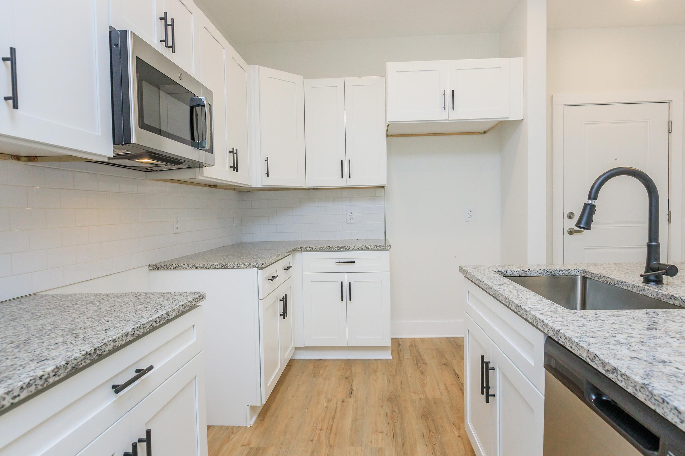 a kitchen with a sink and a refrigerator