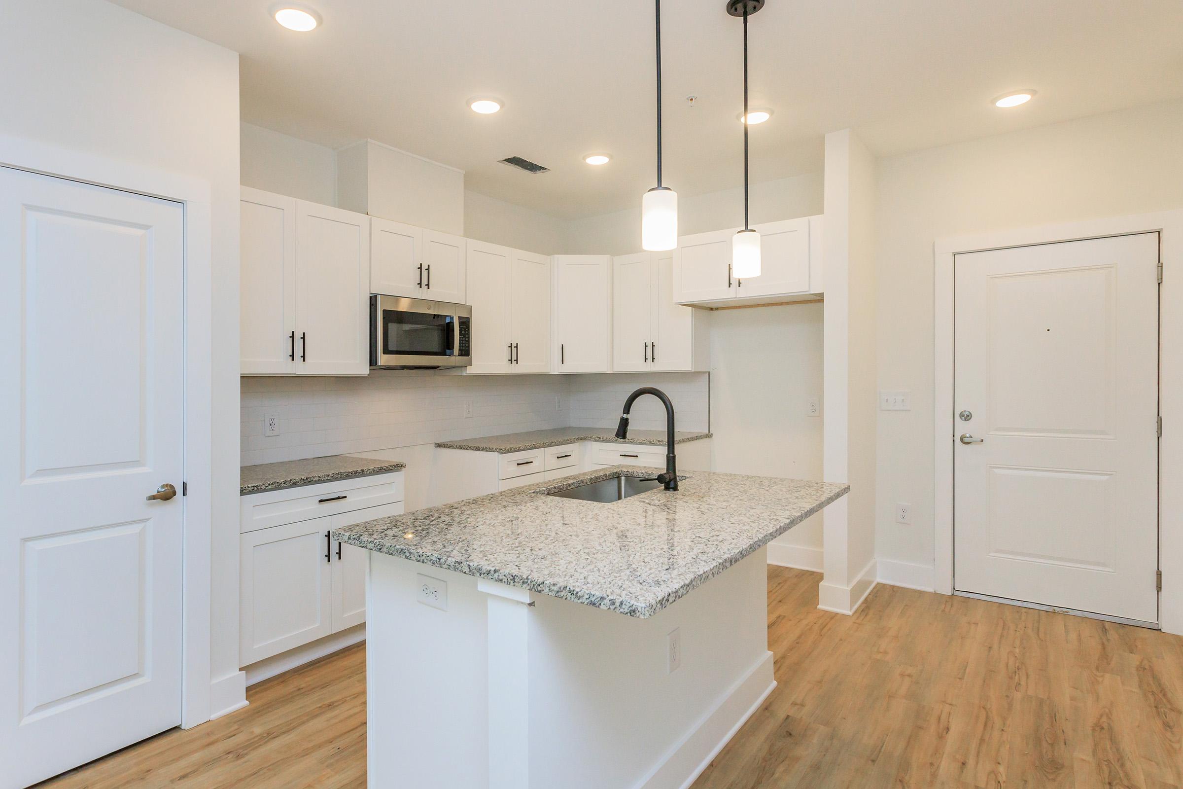 a kitchen with a sink and a mirror