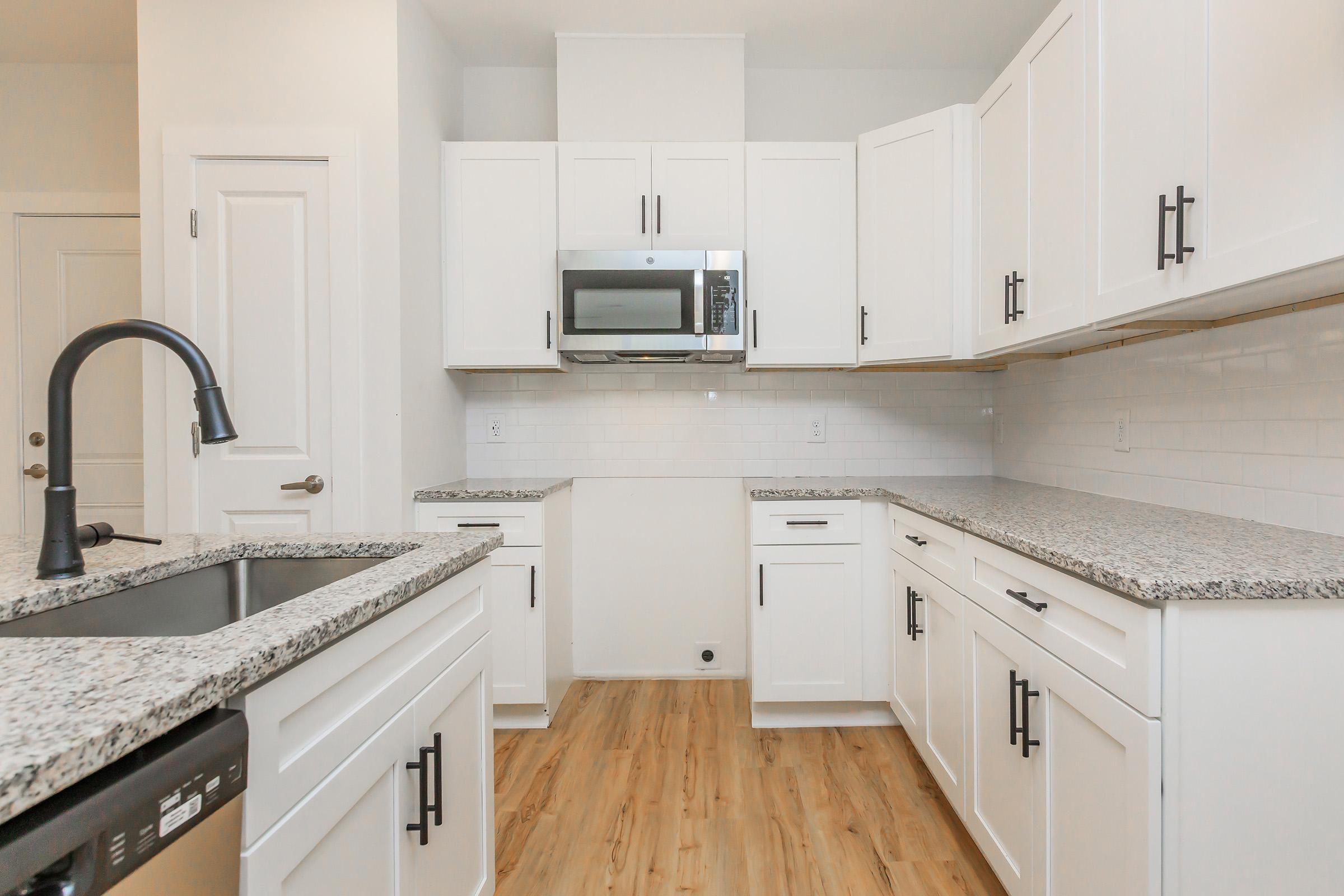 a kitchen with a stove a sink and a microwave