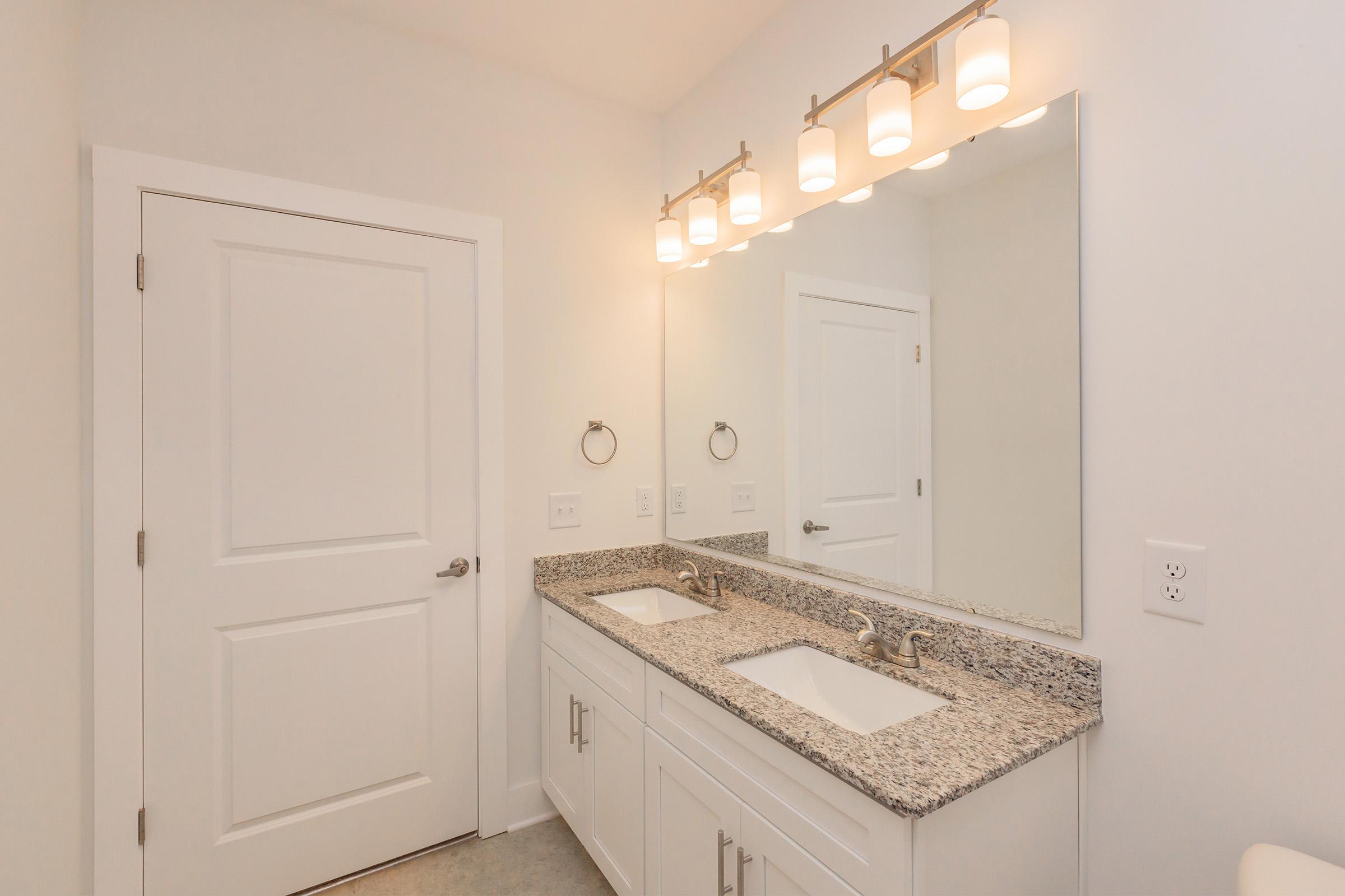 a kitchen with a sink and a mirror