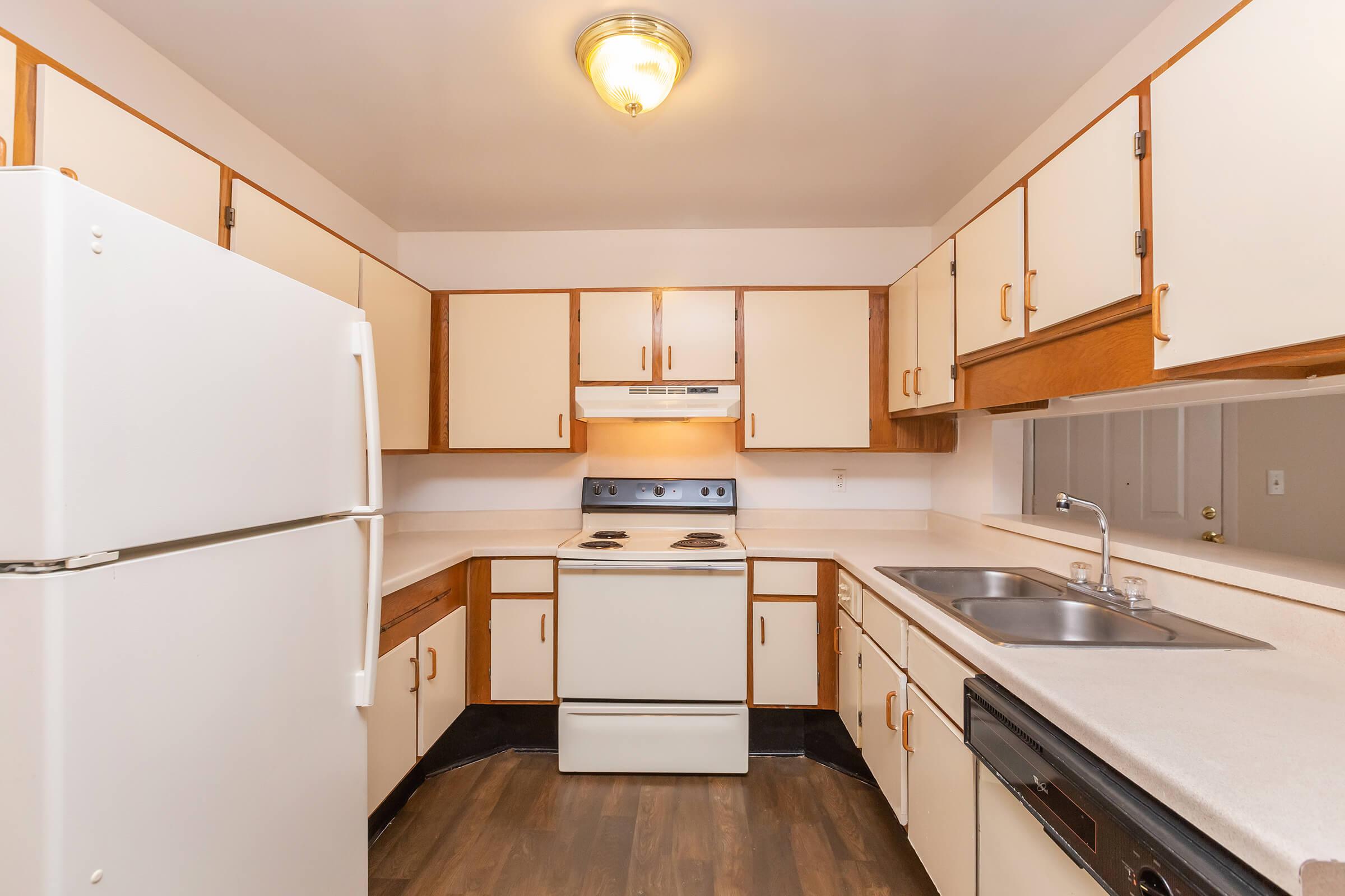 a kitchen with a sink and a refrigerator