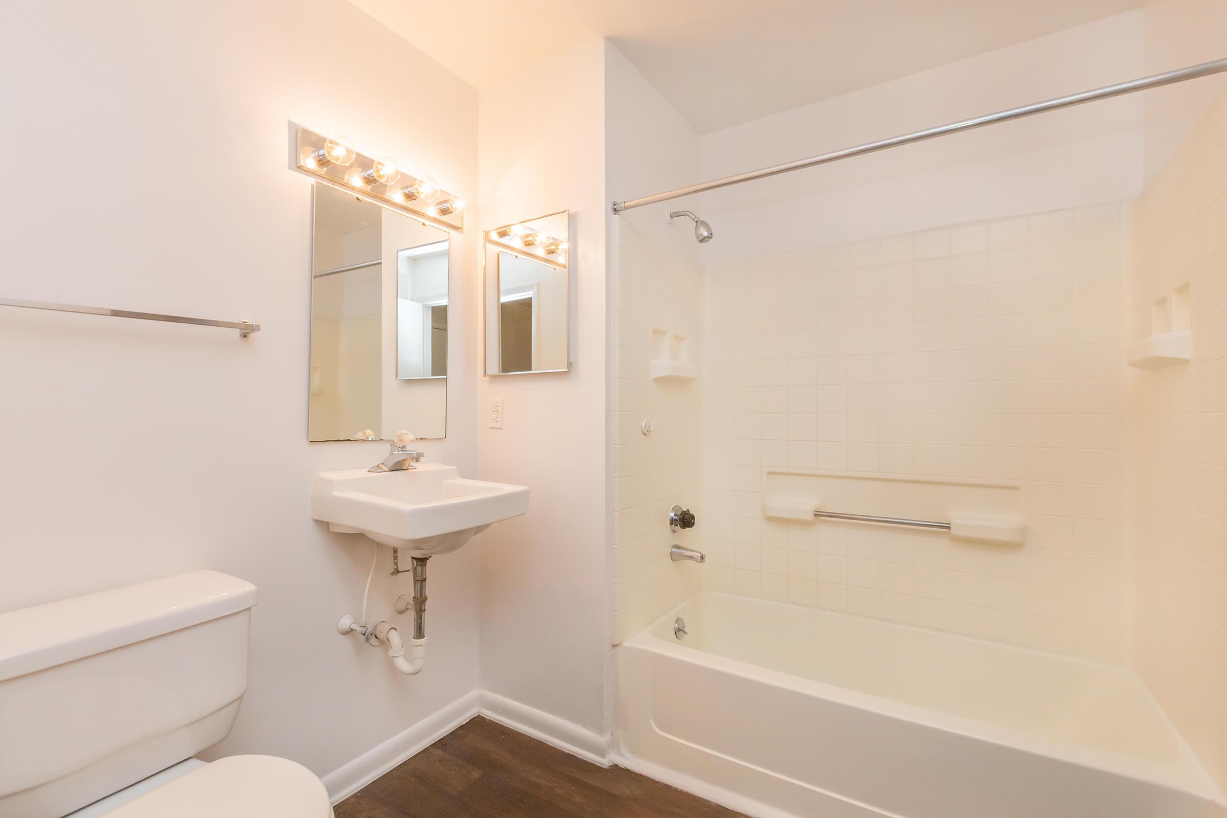 a white tub sitting next to a sink