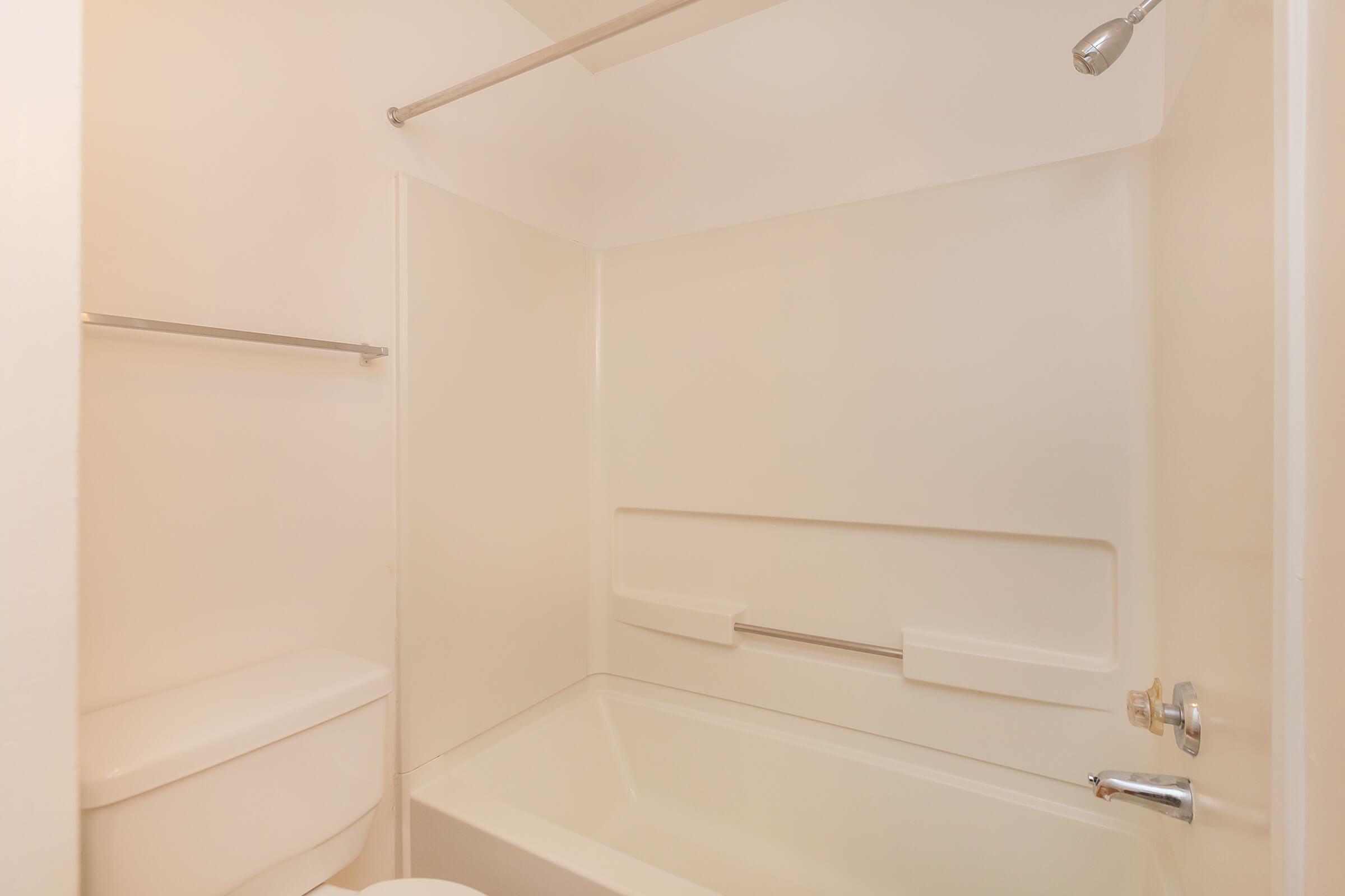 a white tub sitting next to a shower