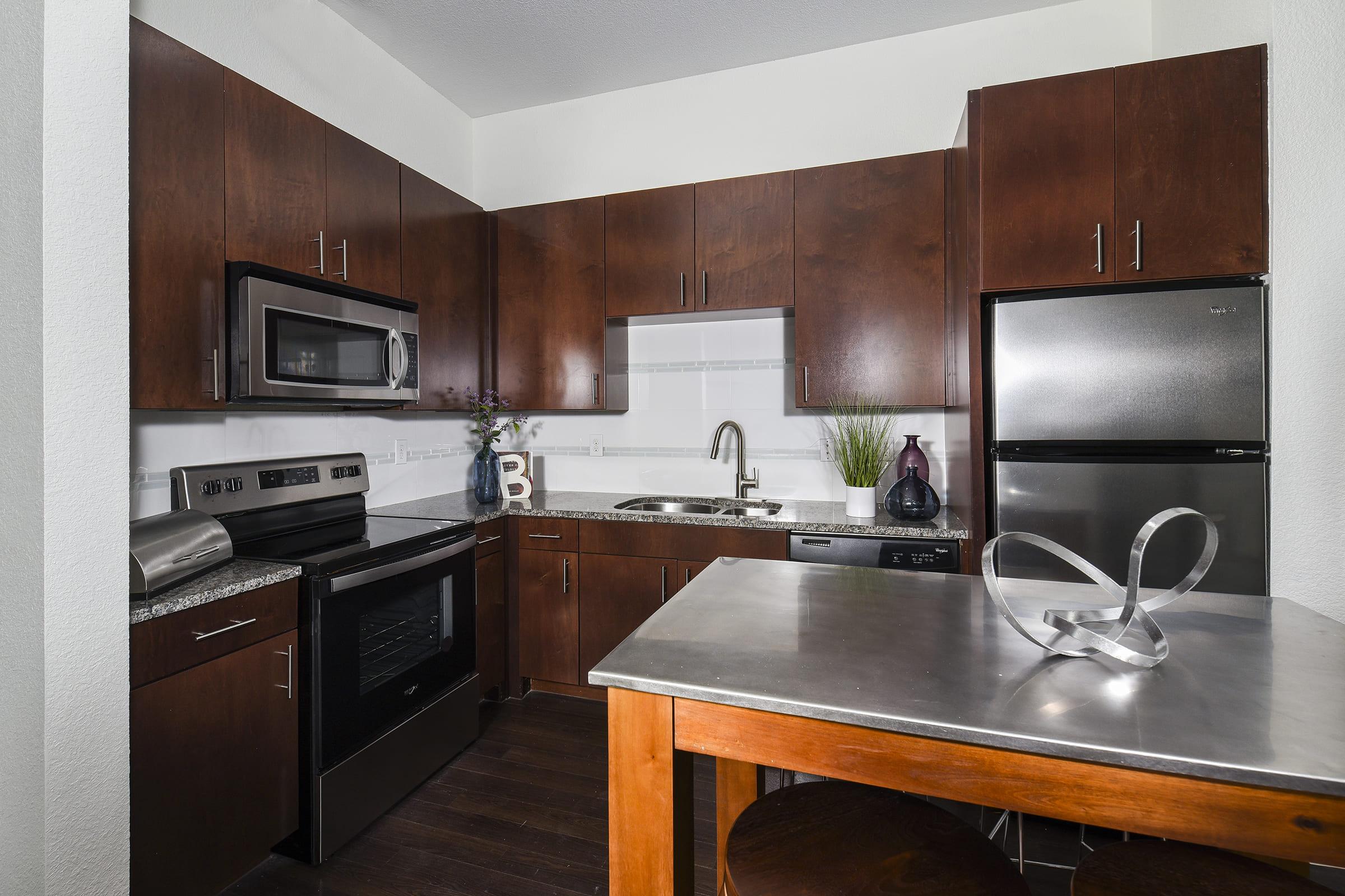 a modern kitchen with stainless steel appliances and wooden cabinets