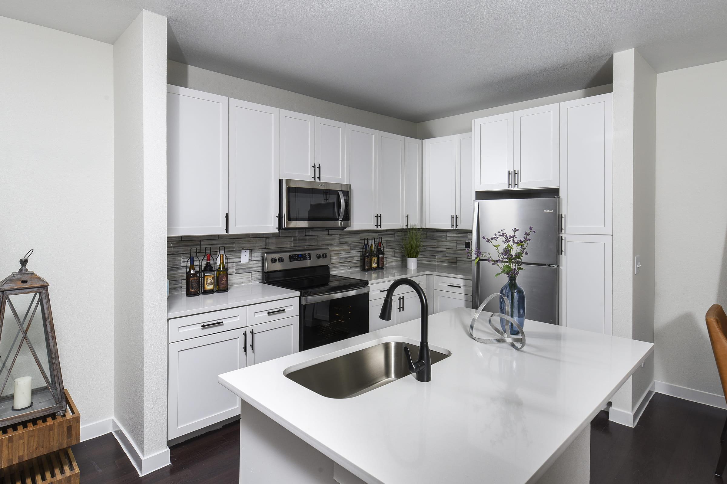 a kitchen with a sink and a dining table