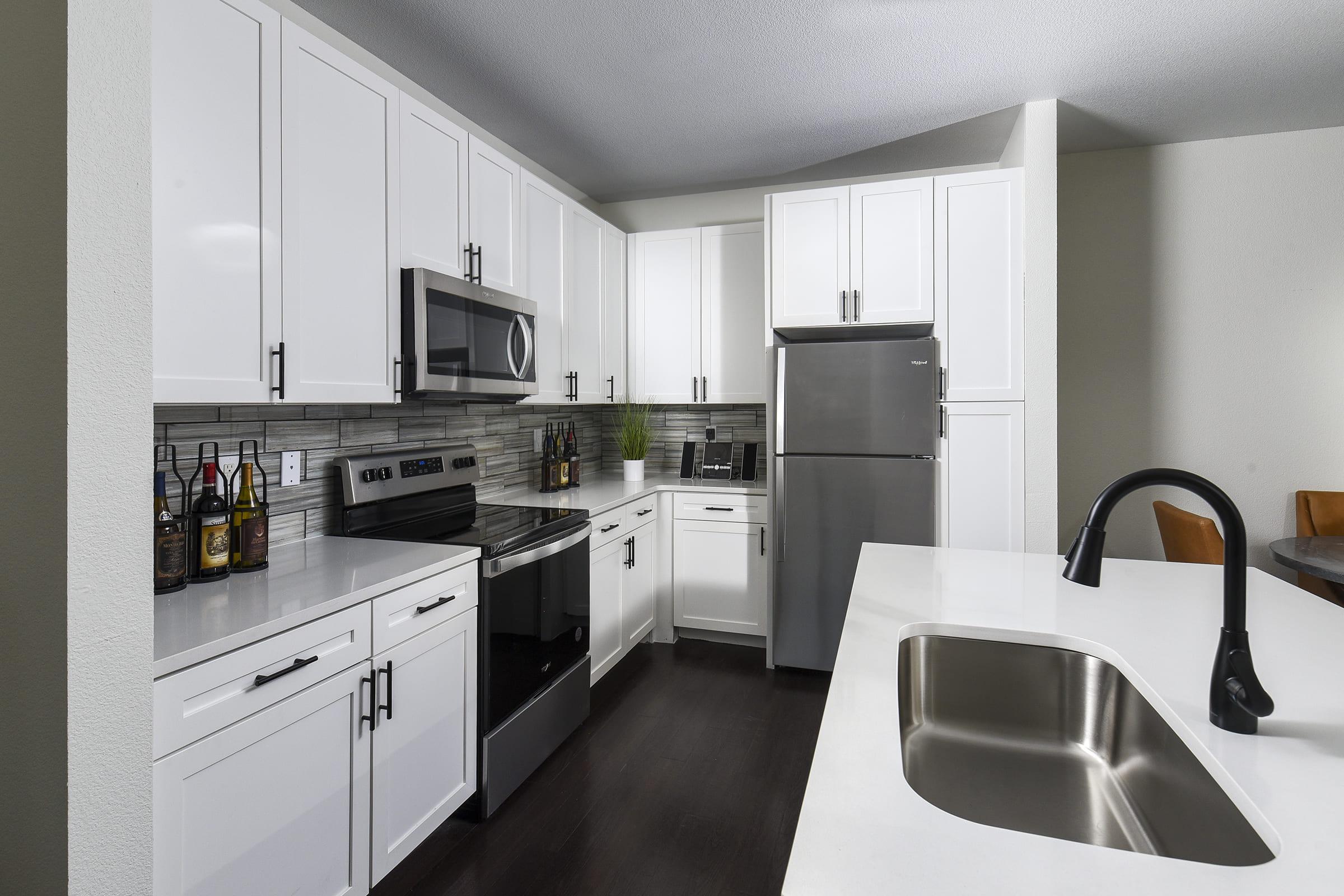 a kitchen with a sink and a refrigerator