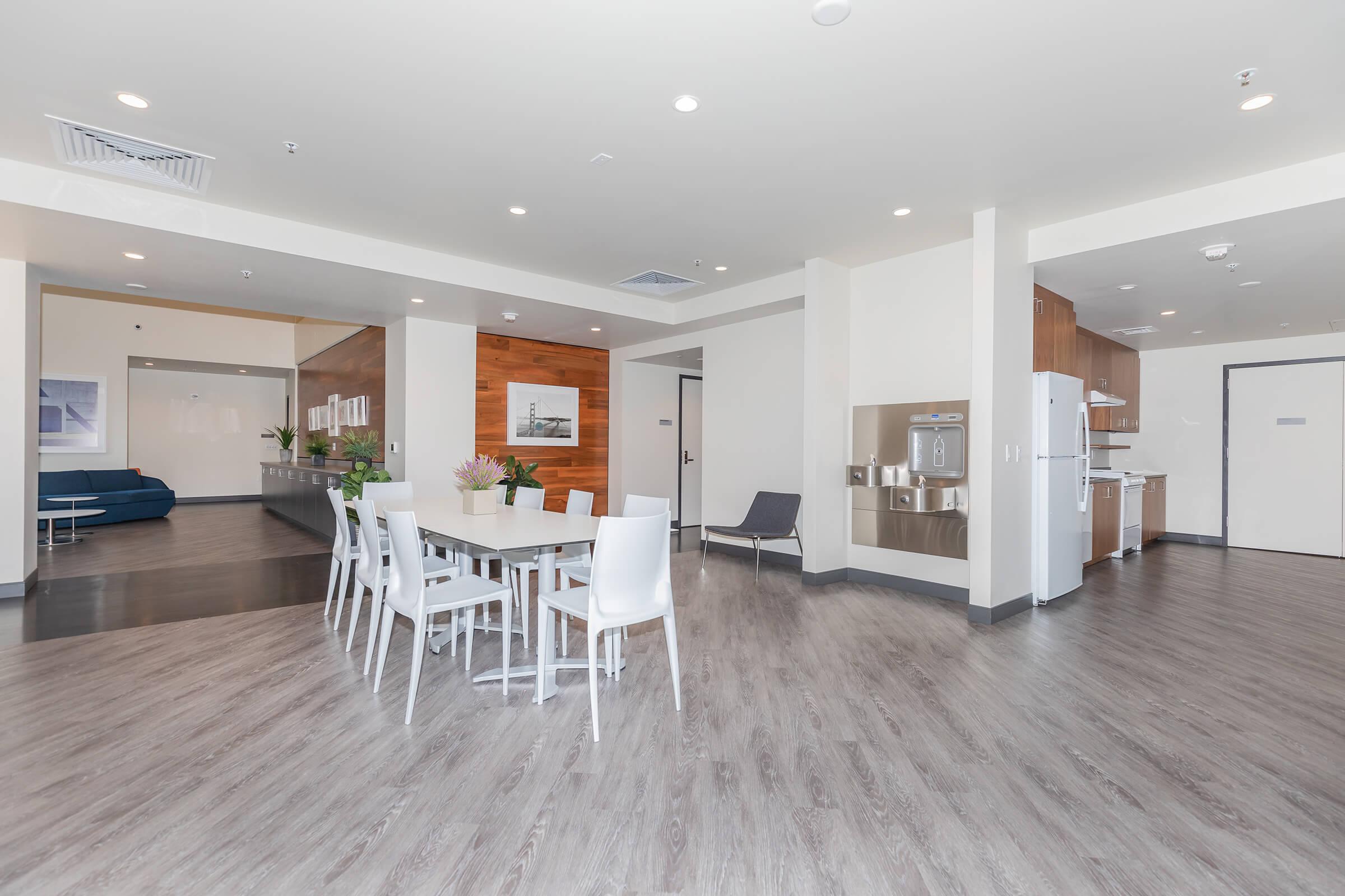 a living room filled with furniture and a wood floor