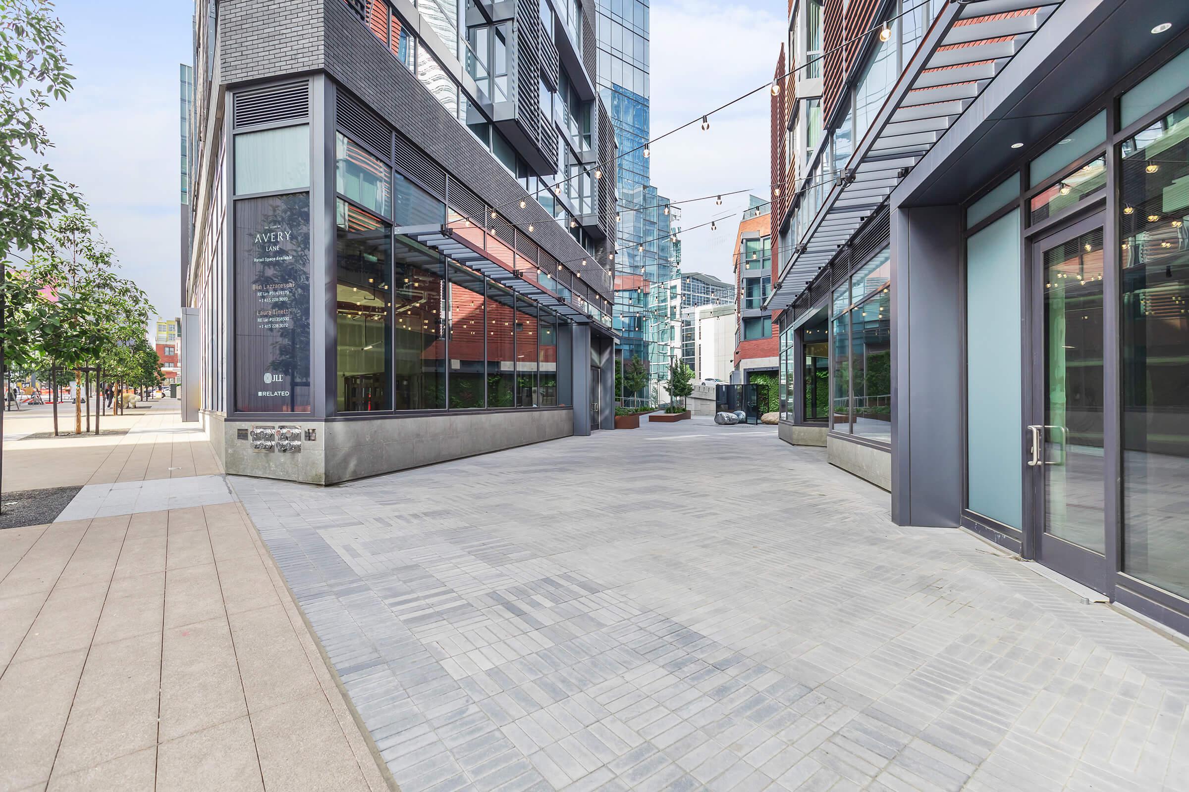 an empty sidewalk in front of a building