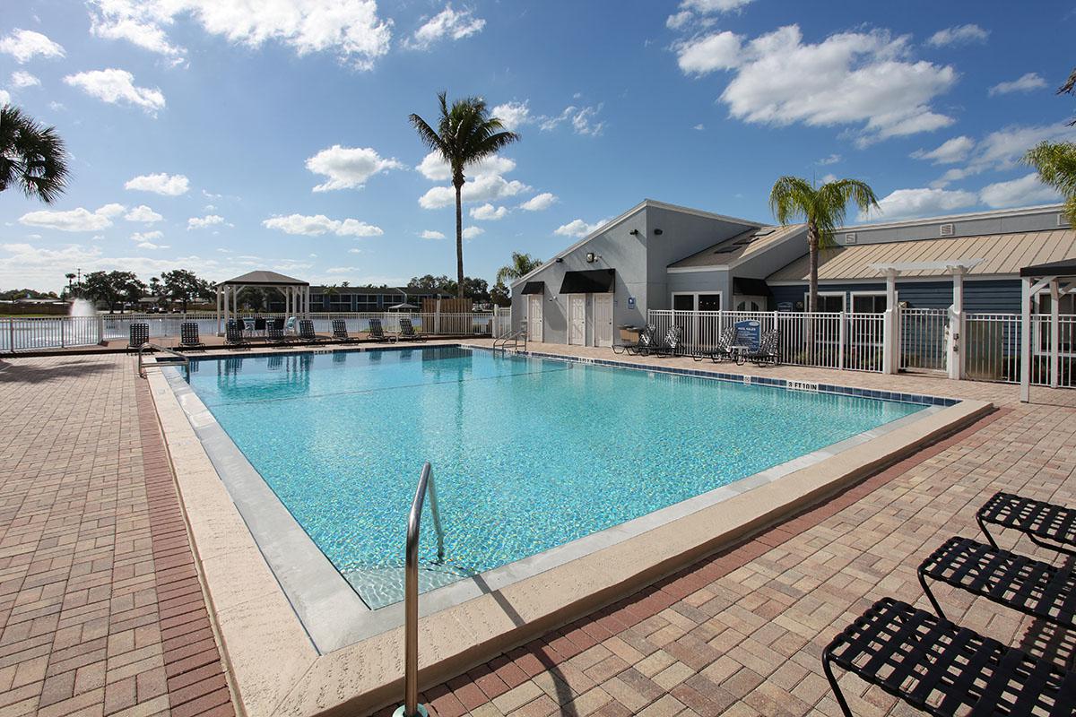 a large brick building with a pool of water