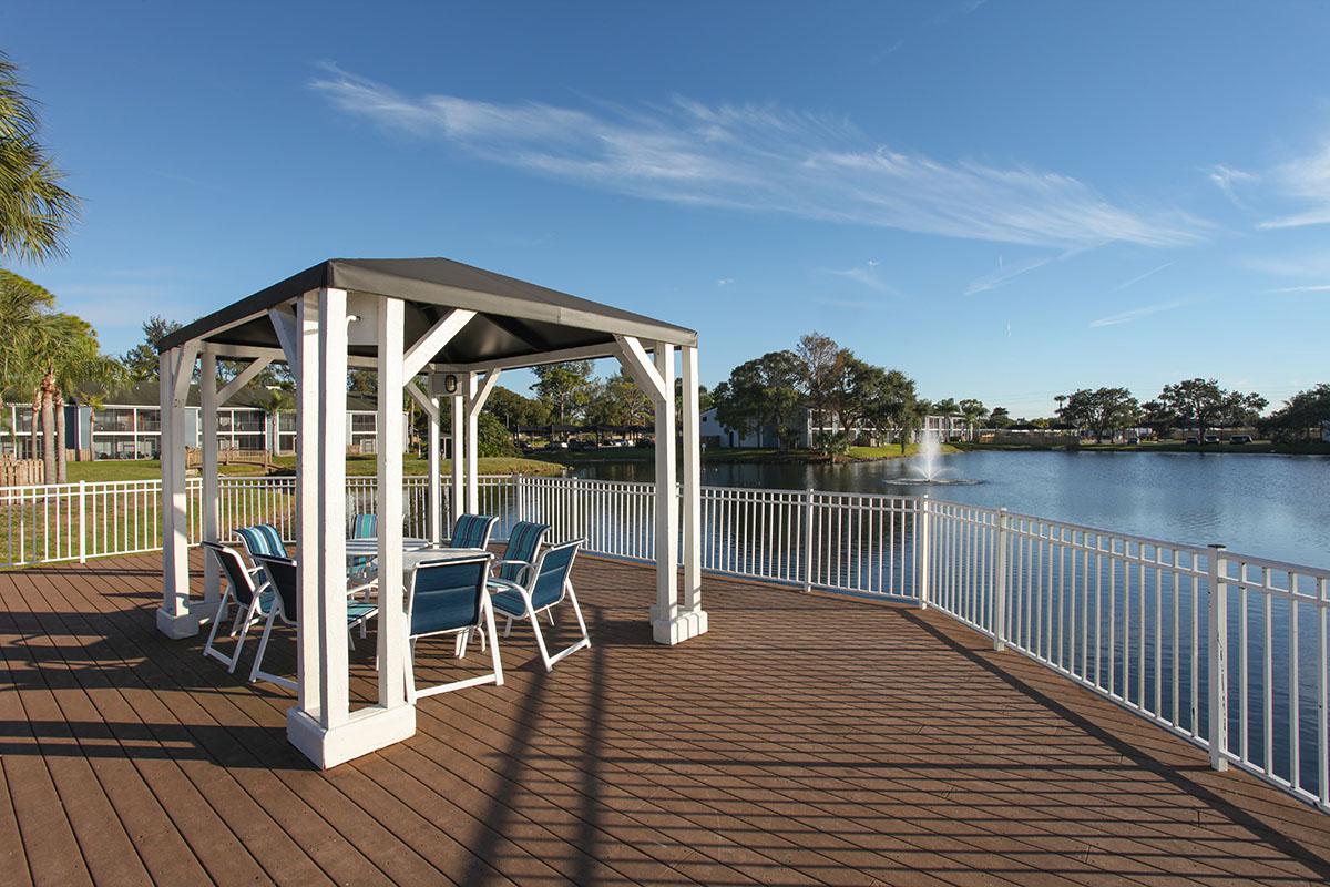 a wooden bench next to a body of water