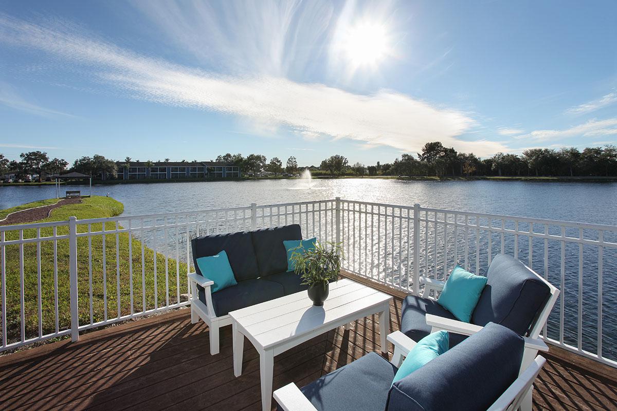 a chair sitting in front of a body of water