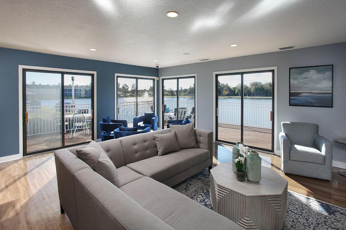 a living room filled with furniture and a large window