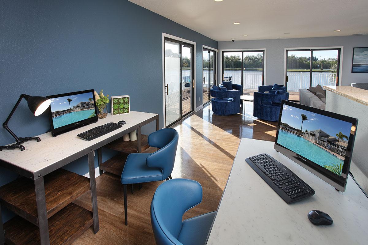 a desk with a laptop computer sitting on top of a table