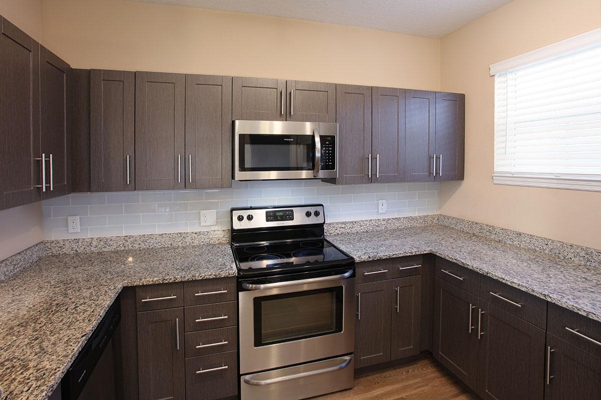 a kitchen with stainless steel appliances and wooden cabinets